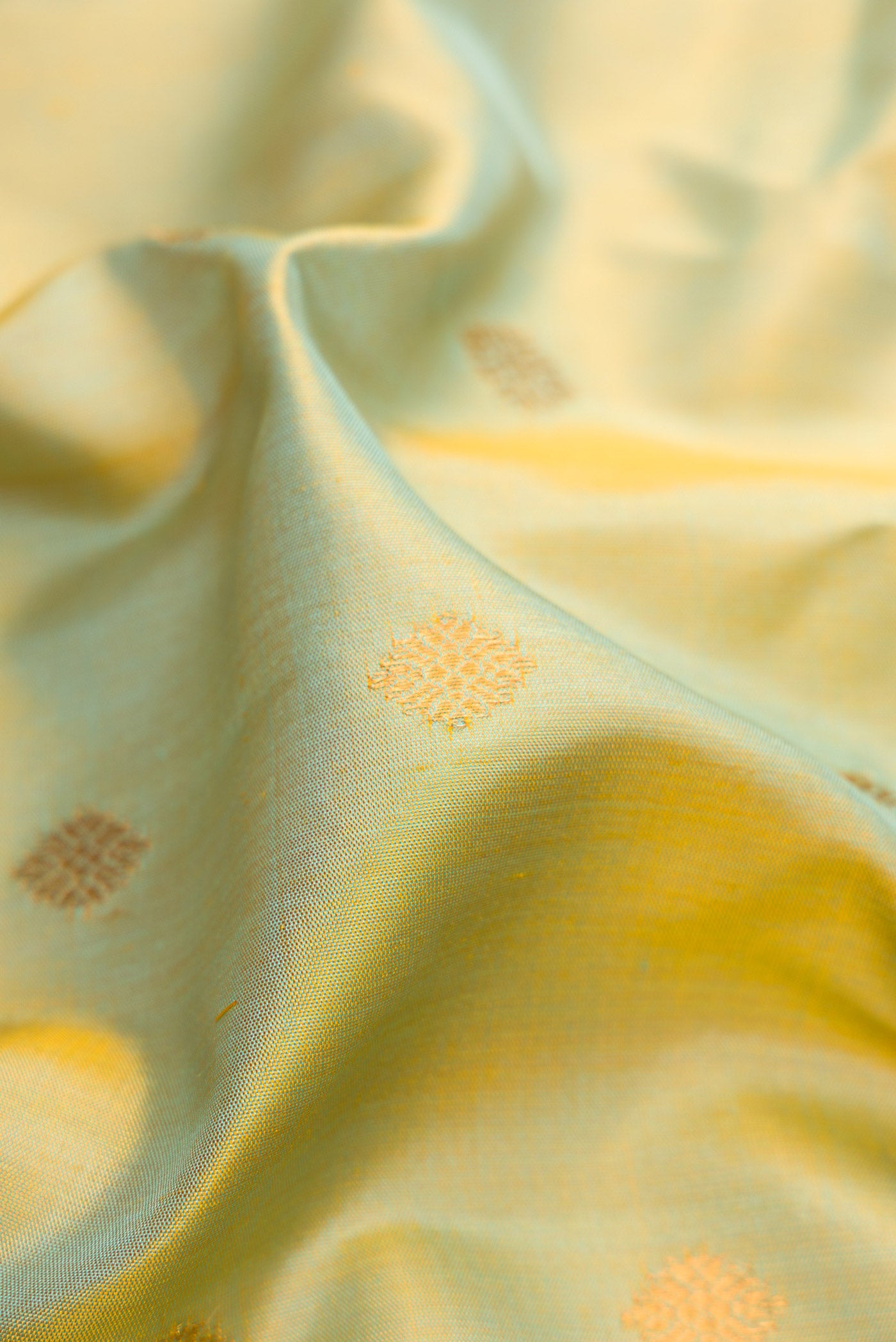 Close up of Mehandi Green Dual Tone Gadwal Silk Saree with Zari Butta on the body and Temple Border.  displaying folds