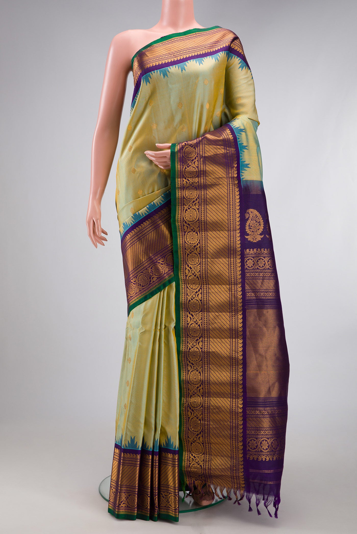 Mehandi Green Dual Tone Gadwal Silk Saree with Zari Butta on the body and Temple Border.  displayed on a mannequin