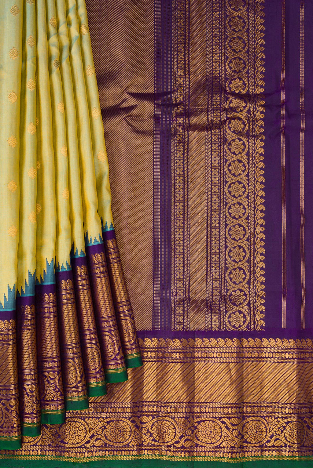 Pleats and pallu of Mehandi Green Dual Tone Gadwal Silk Saree with Zari Butta on the body and Temple Border. 