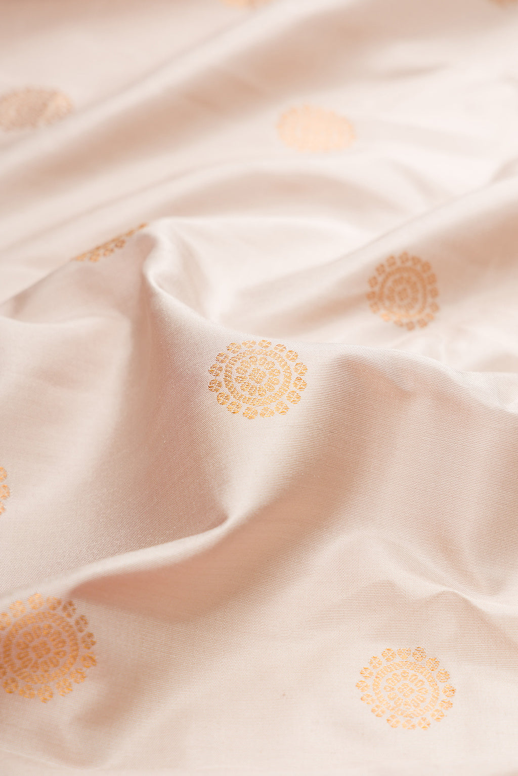 Close up of Dark Beige Gadwal Silk Saree with Zari Butta on the body and Fancy Border.  displaying folds