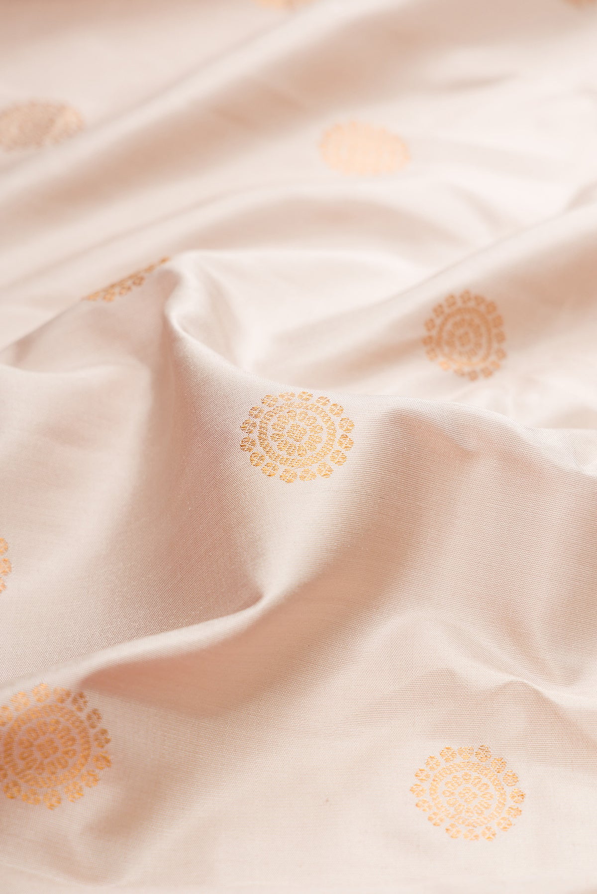 Close up of Dark Beige Gadwal Silk Saree with Zari Butta on the body and Fancy Border.  displaying folds