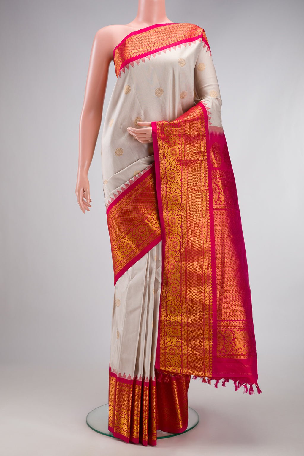 Dark Beige Gadwal Silk Saree with Zari Butta on the body and Fancy Border.  displayed on a mannequin