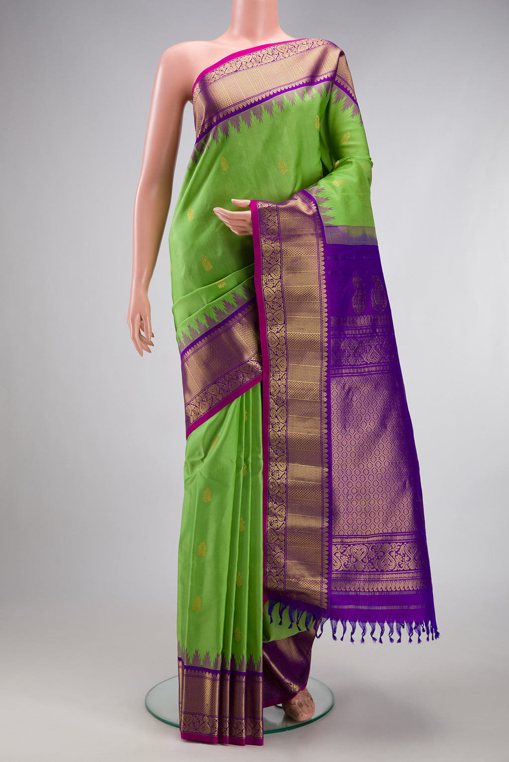 Parrot Green Gadwal Silk Saree with Zari Butta on the body and Fancy Border.  displayed on a mannequin