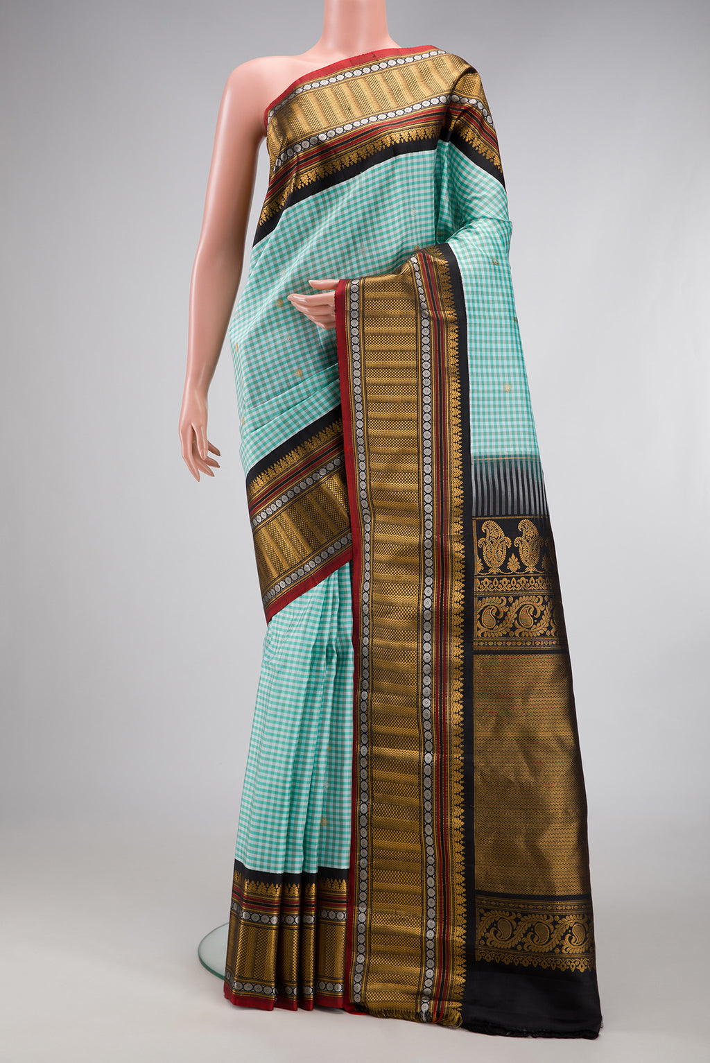Light Blue Gadwal Silk Saree with Checked design on the body and Zari Border.  displayed on a mannequin