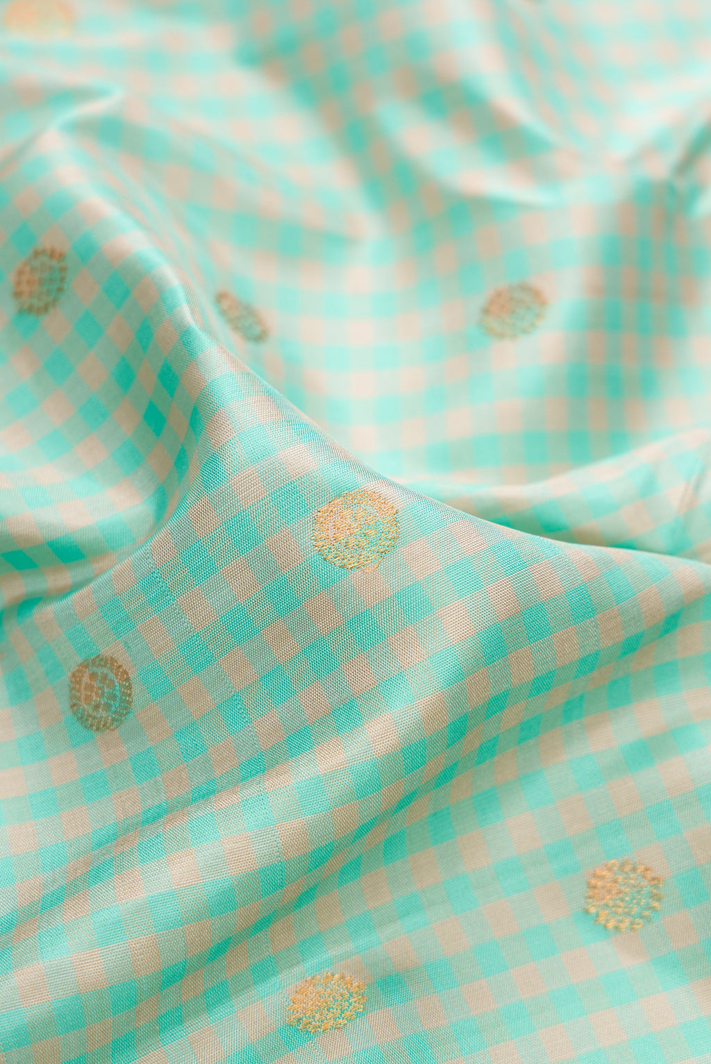 Close up of Light Blue Gadwal Silk Saree with Checked design on the body and Temple Border.  displaying folds
