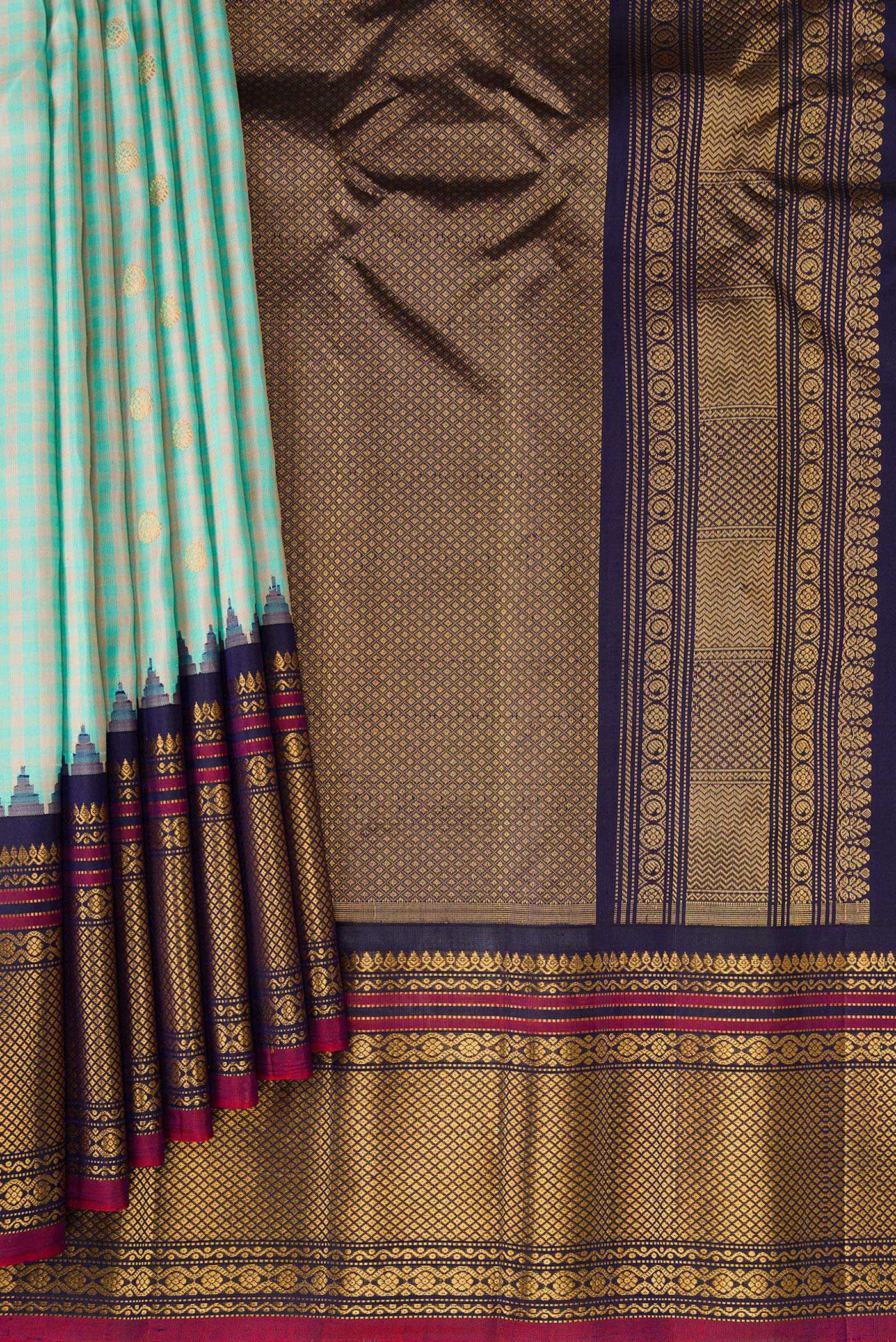 Pleats and pallu of Light Blue Gadwal Silk Saree with Checked design on the body and Temple Border. 