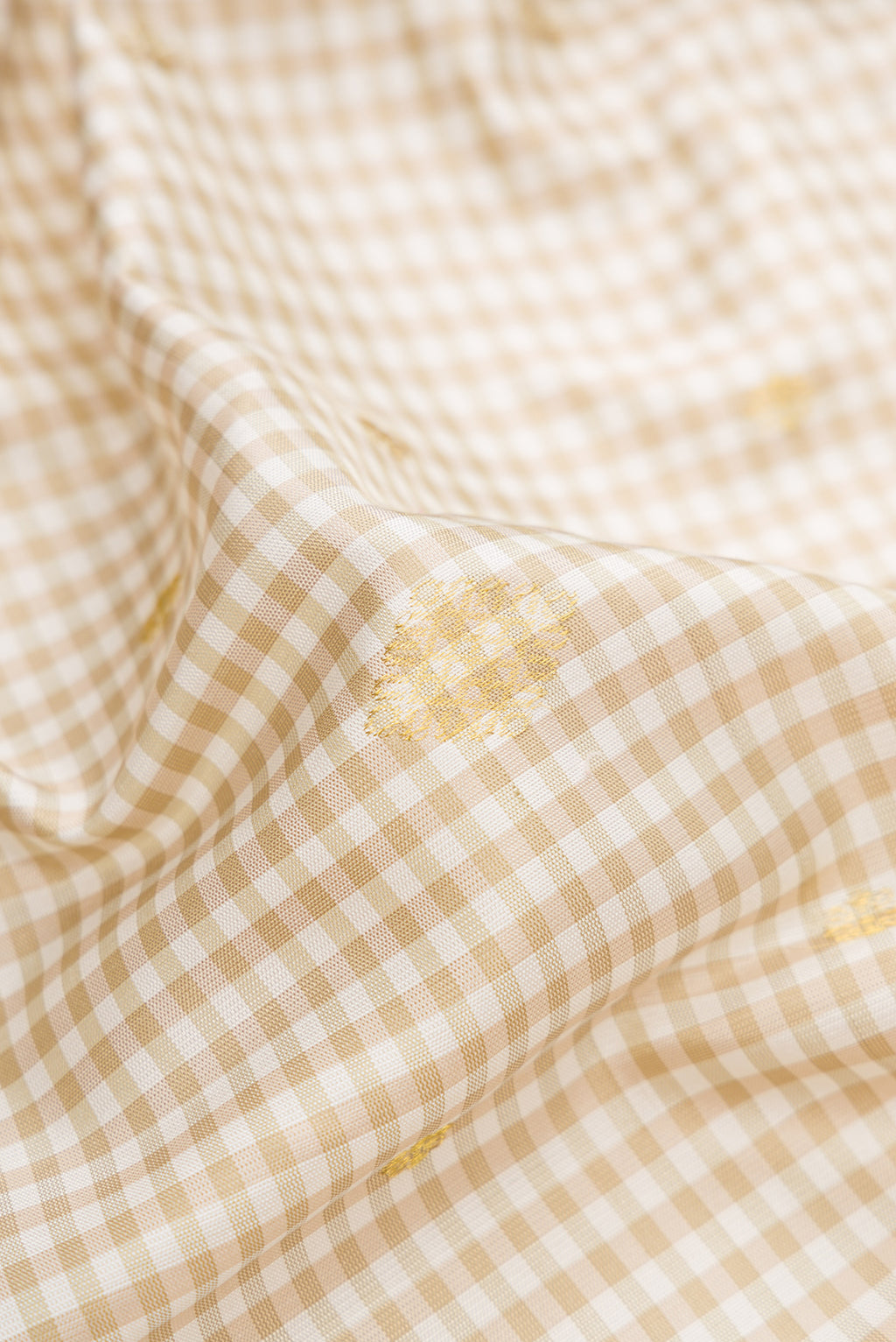 Close up of Cream Gadwal Silk Saree with Checked design on the body and Temple Border.  displaying folds