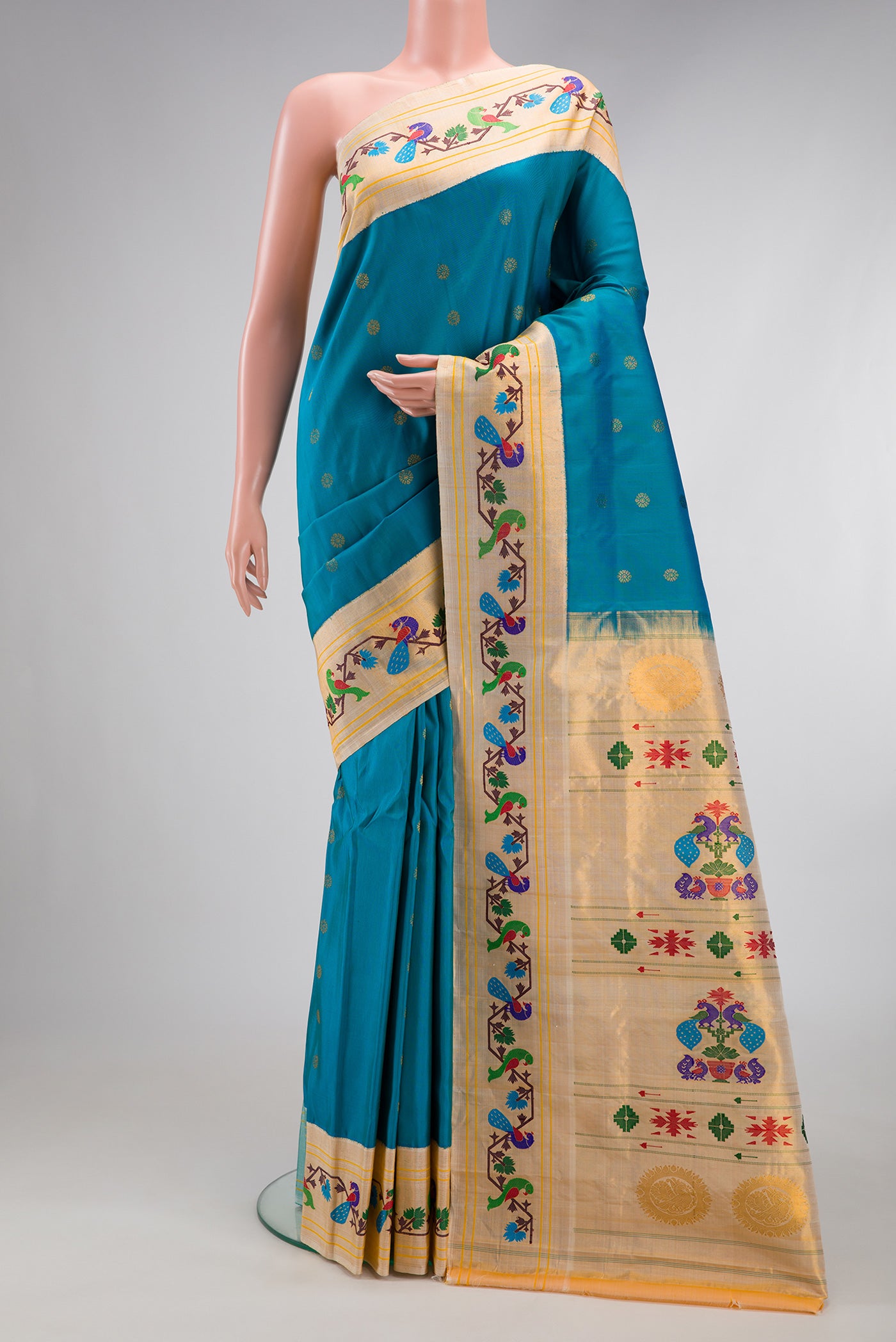 Peacock Blue Paithani Silk Saree with Zari Butta on the body and Paithani Border.  displayed on a mannequin