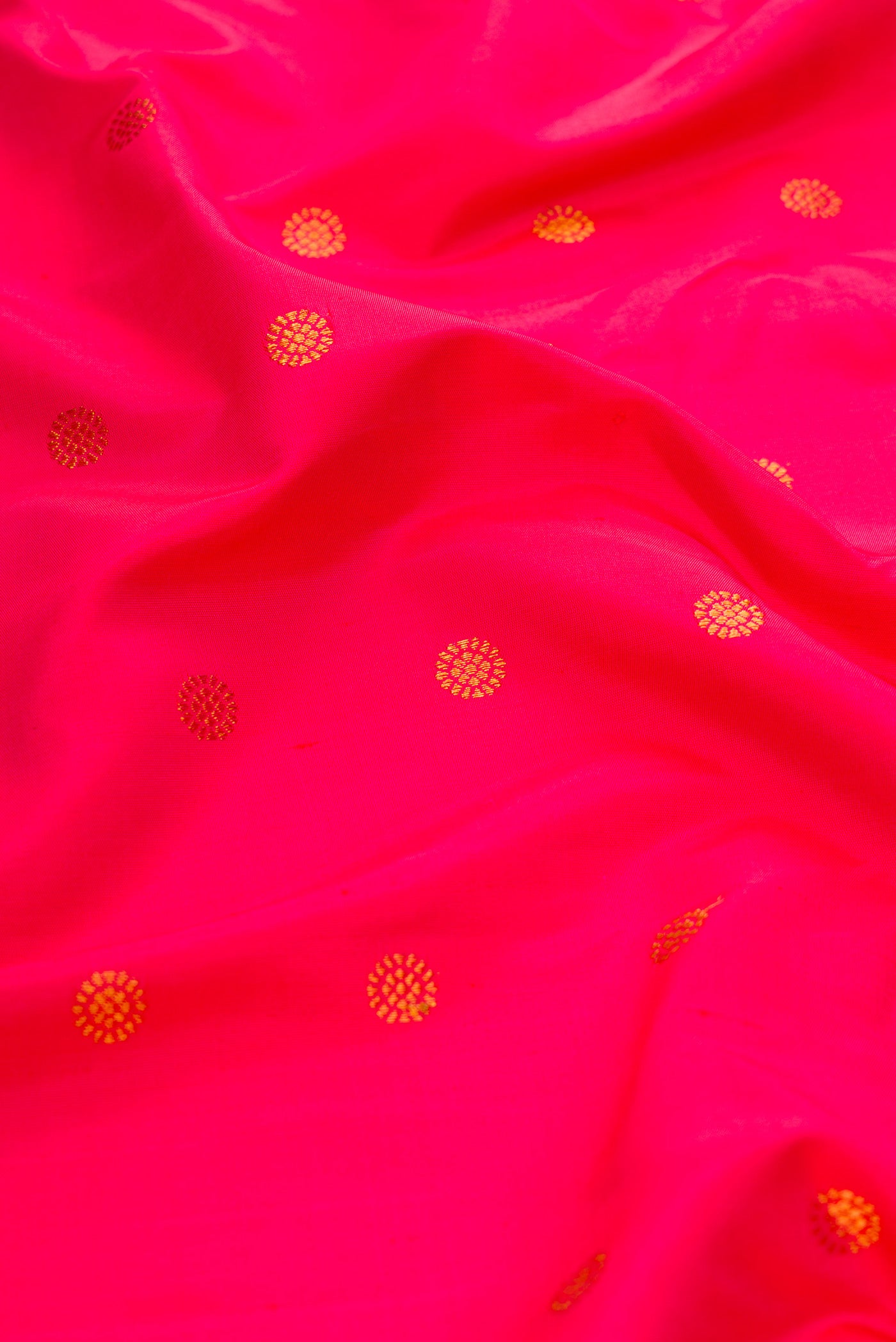 Close up of Pink Dual Tone Paithani Silk Saree with Zari Butta on the body and Paithani Border.  displaying folds