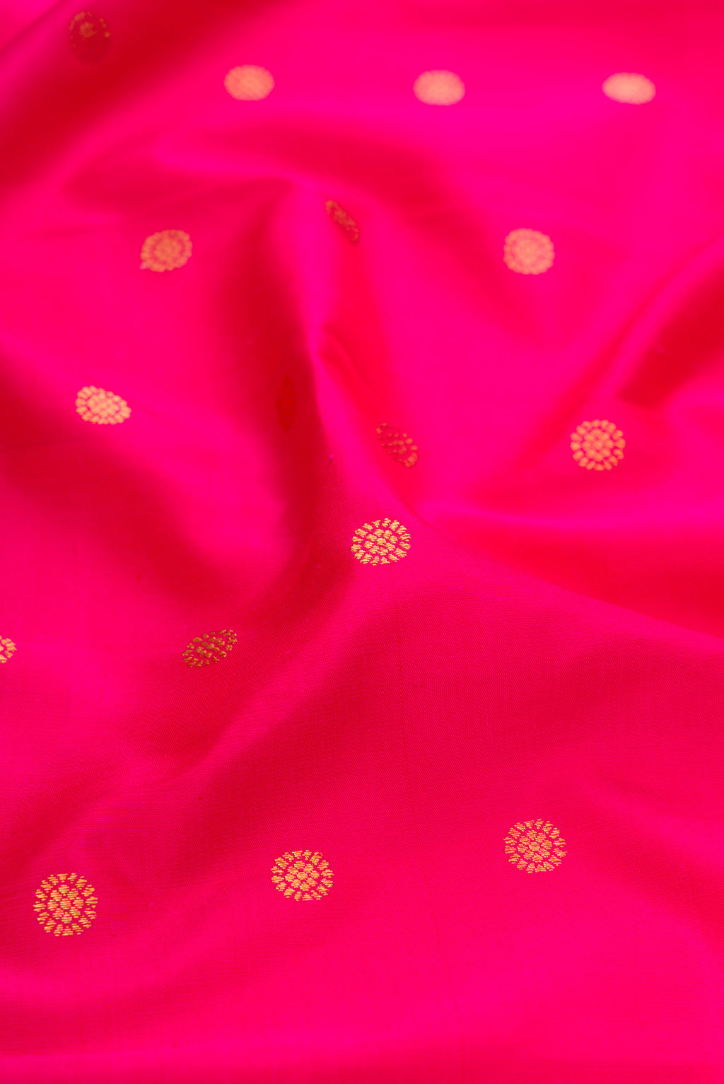 Close up of Dark Pink Paithani Silk Saree with Zari Butta on the body and Paithani Border.  displaying folds