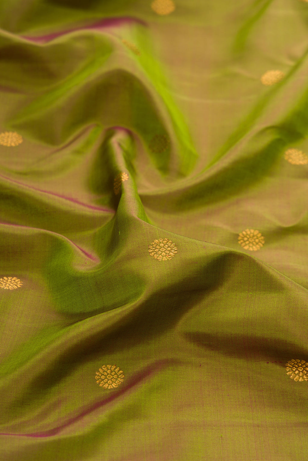 Close up of Mehandi Green Dual Tone Paithani Silk Saree with Zari Butta on the body and Fancy Border.  displaying folds