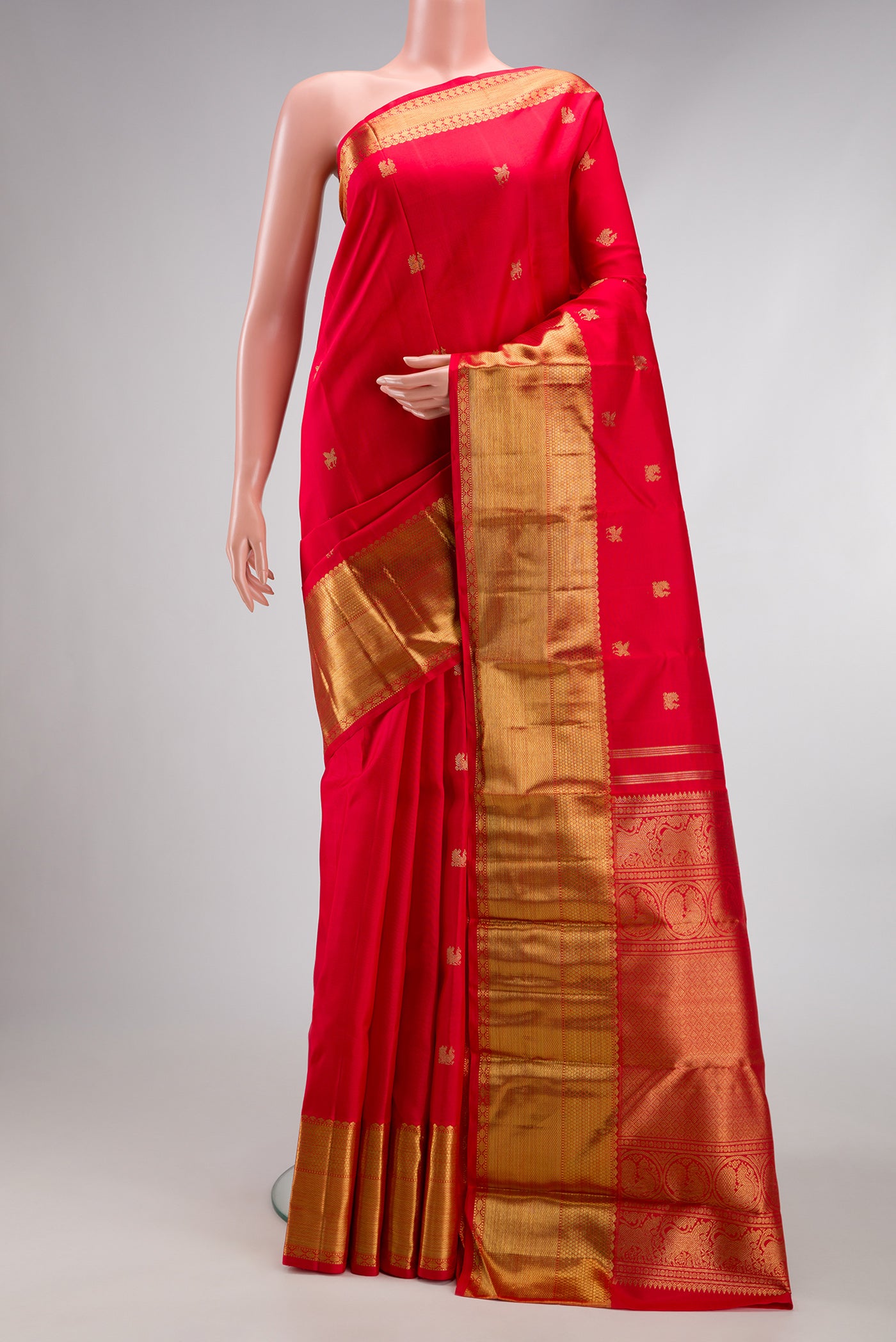Pure Silk Pure Zari Red Dual Tone Kanjivaram Saree with Zari Butta on the body and Zari Border.  displayed on a mannequin