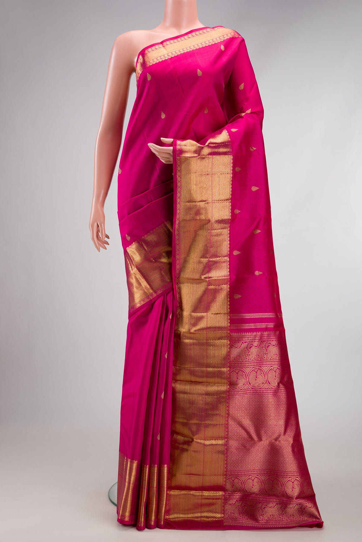 Pure Silk Pure Zari Dark Pink Kanjivaram Saree with Zari Butta on the body and Zari Border.  displayed on a mannequin