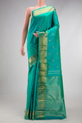 Pure Silk Pure Zari Turquoise Kanjivaram Saree with Zari Butta on the body and Zari Border.  displayed on a mannequin