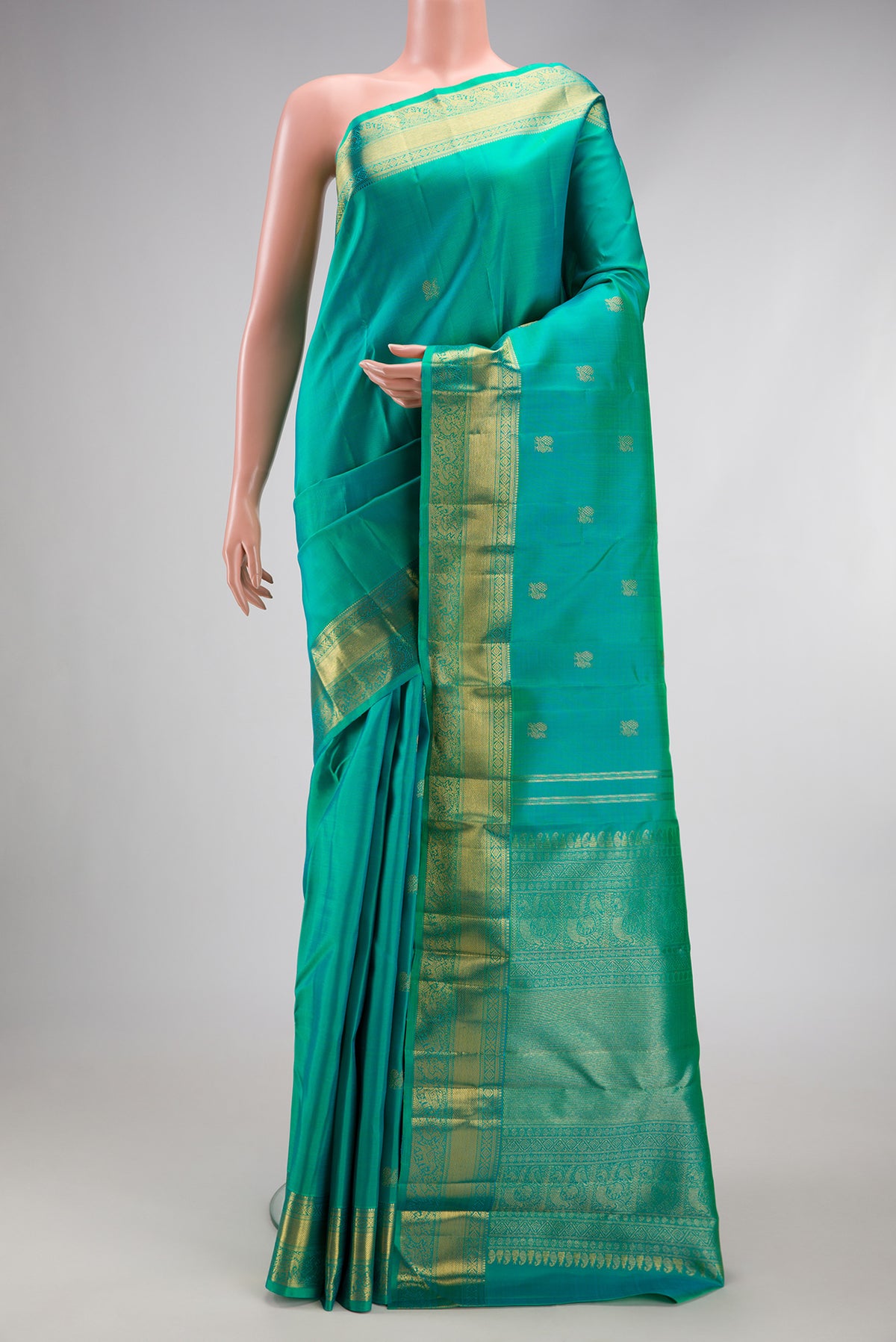 Pure Silk Pure Zari Turquoise Kanjivaram Saree with Zari Butta on the body and Zari Border.  displayed on a mannequin