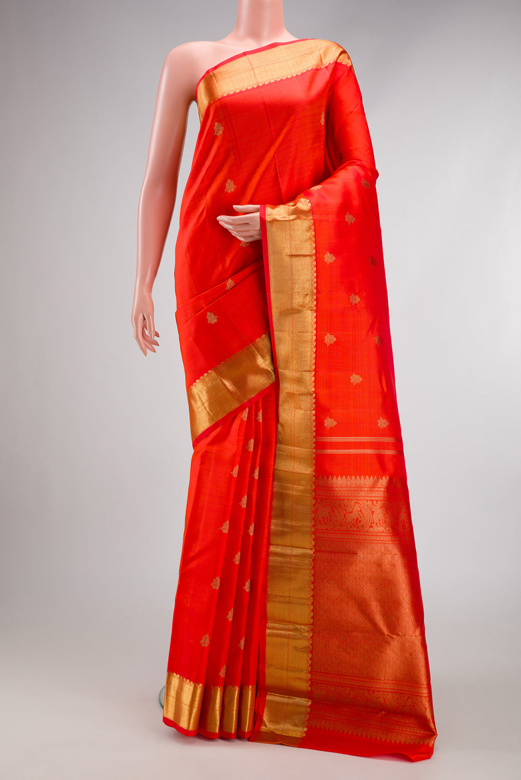 Pure Silk Pure Zari Orange Dual Tone Kanjivaram Saree with Zari Butta on the body and Zari Border.  displayed on a mannequin