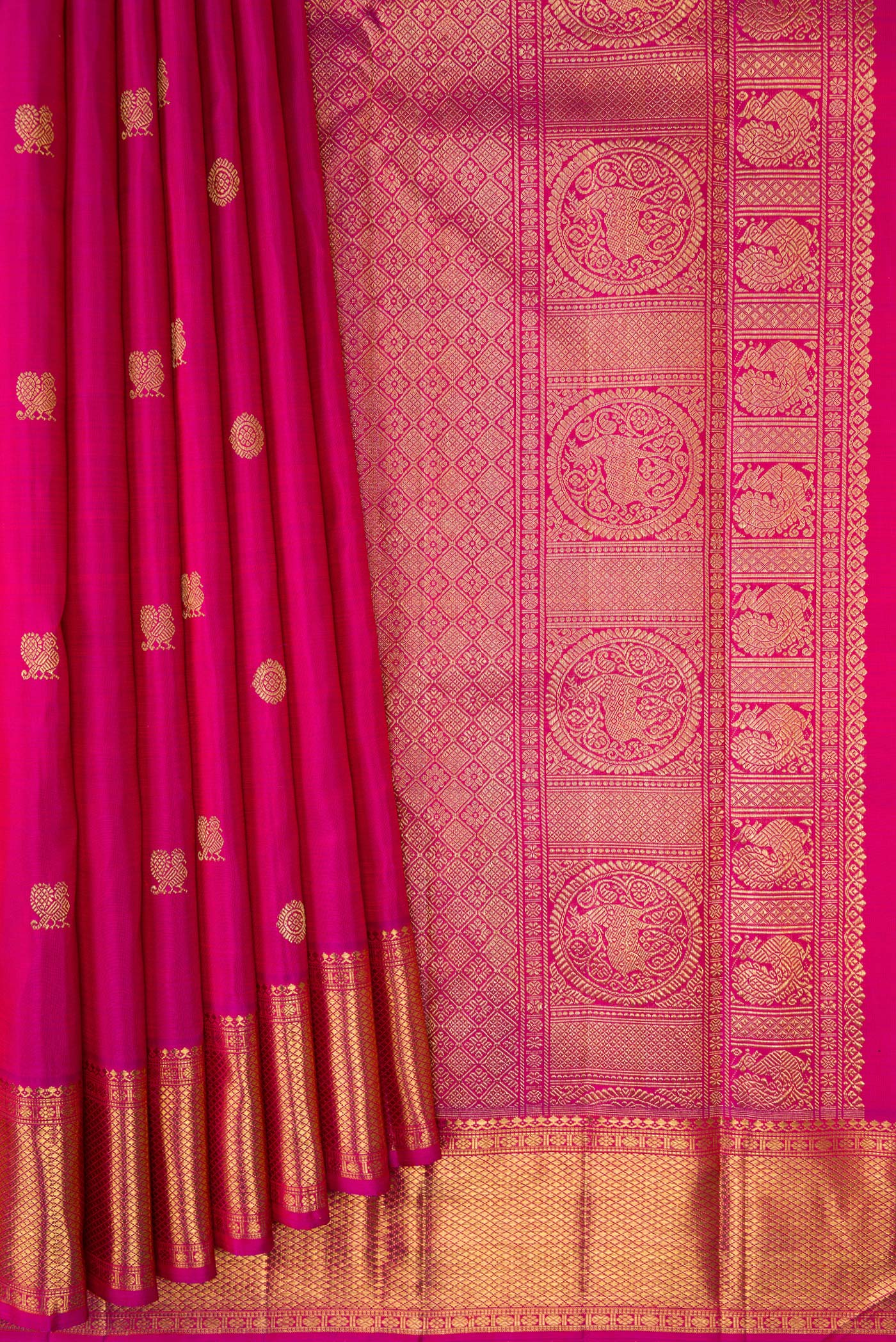 Pleats and pallu of Pure Silk Pure Zari Magenta Kanjivaram Saree with Zari Butta on the body and Zari Border. 