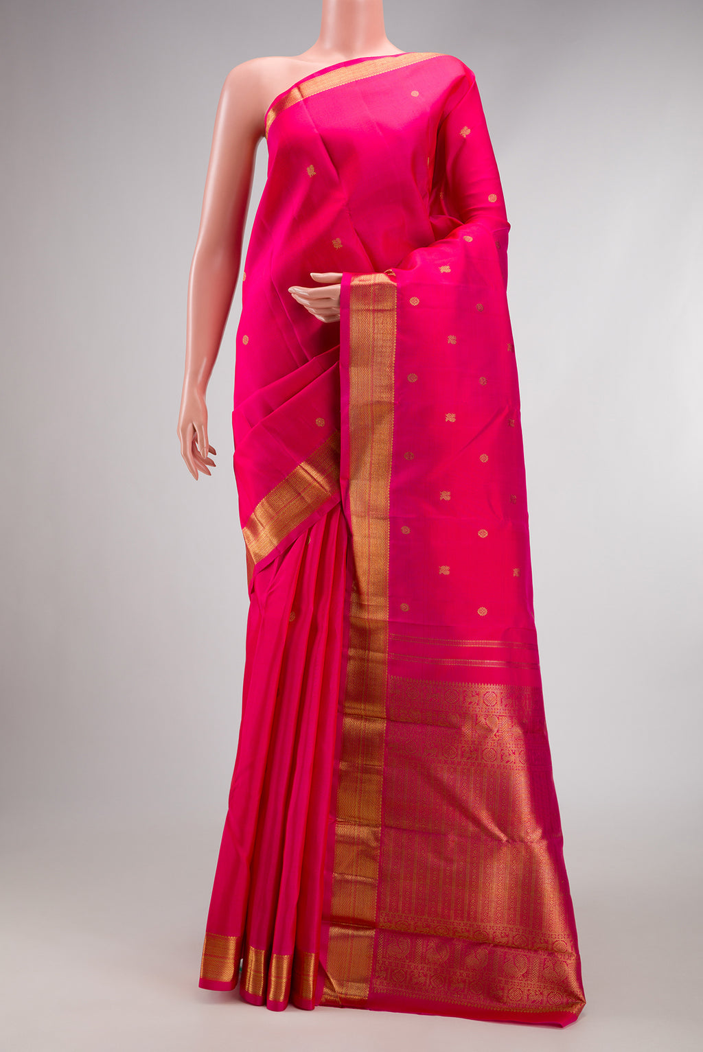 Pure Silk Pure Zari Pink Kanchipuram Saree with Zari Butta on the body and Zari Border.  displayed on a mannequin