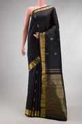 Black Kanchipuram Silk Saree with Zari Butta on the body and Zari Border.  displayed on a mannequin
