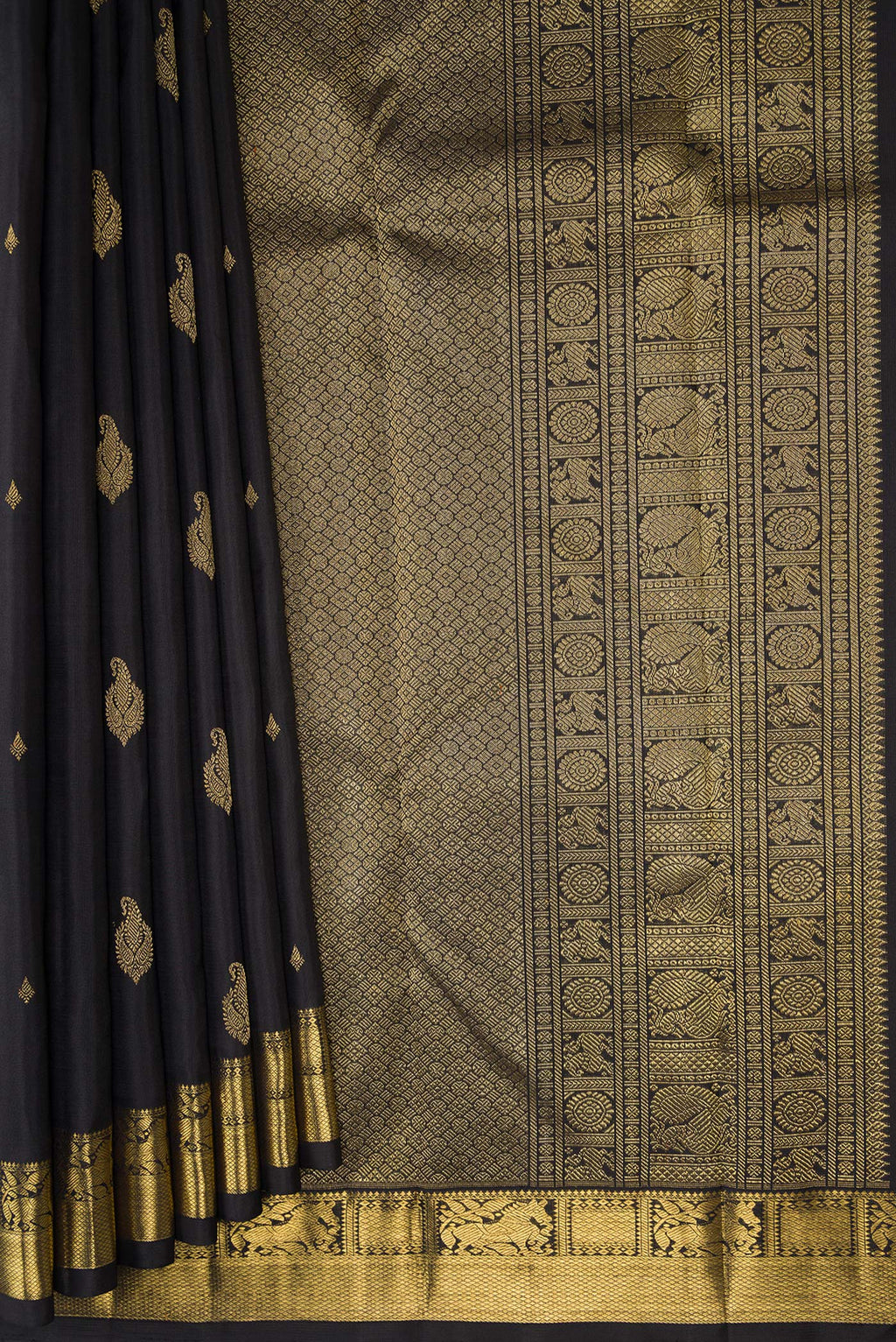 Pleats and pallu of Black Kanchipuram Silk Saree with Zari Butta on the body and Zari Border. 