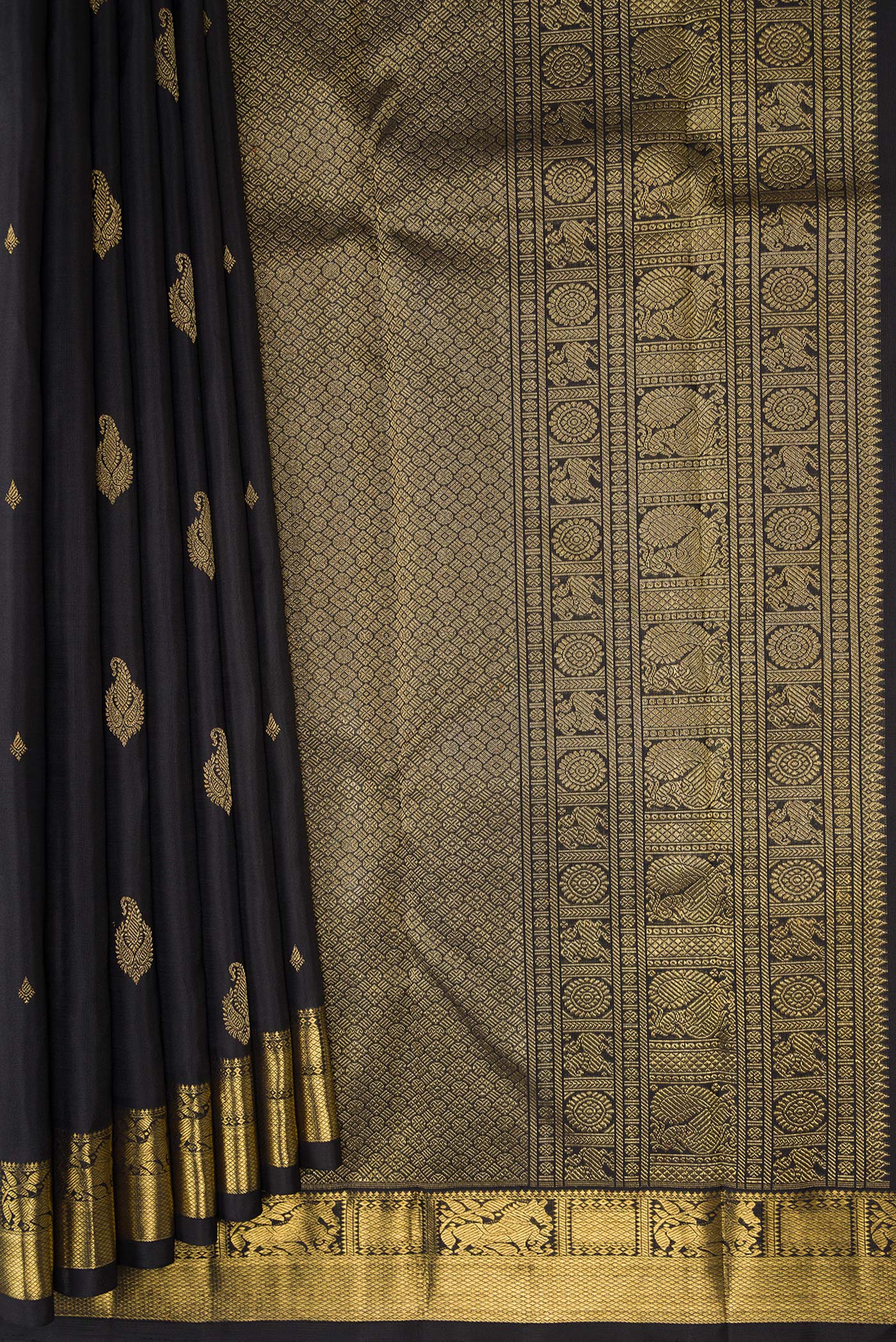 Pleats and pallu of Black Kanchipuram Silk Saree with Zari Butta on the body and Zari Border. 