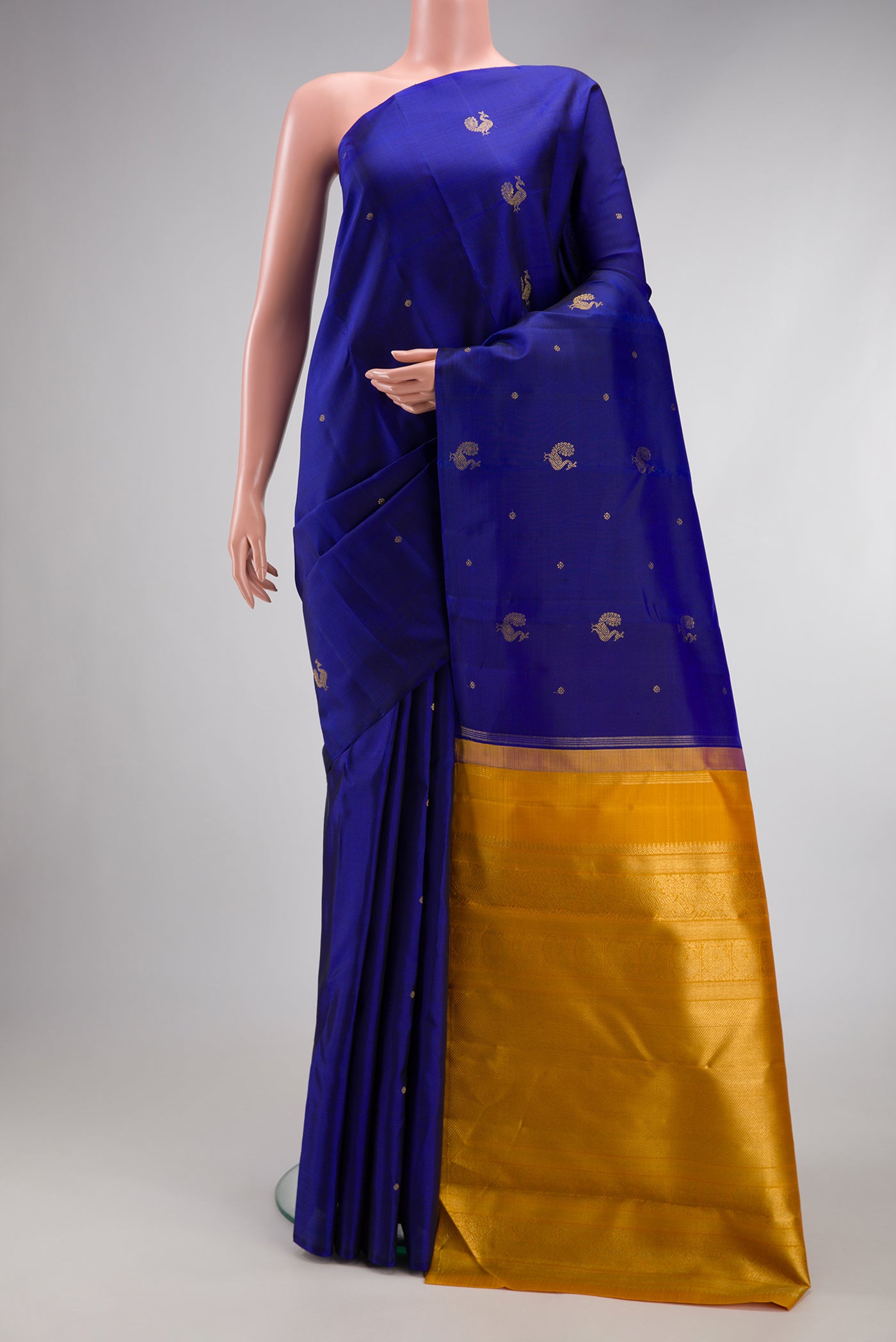 Pure Silk Pure Zari Royal Blue Kanchipuram Saree with Zari Butta on the body and Without Border.  displayed on a mannequin