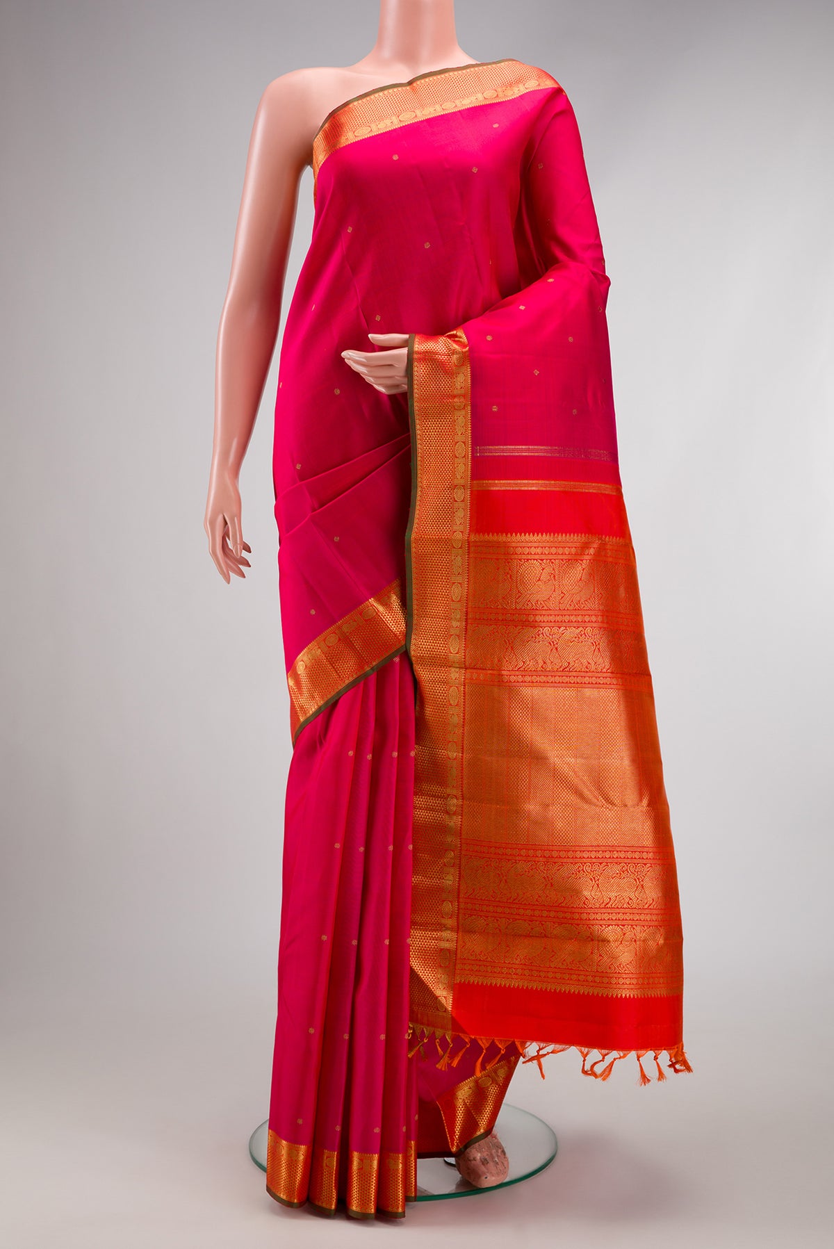 Pure Silk Pure Zari Pink Kanjivaram Saree with Zari Butta on the body and Zari Border.  displayed on a mannequin