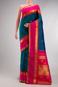 Pure Silk Pure Zari Peacock Blue Kanjivaram Saree with Zari Butta on the body and Zari Border.  displayed on a mannequin
