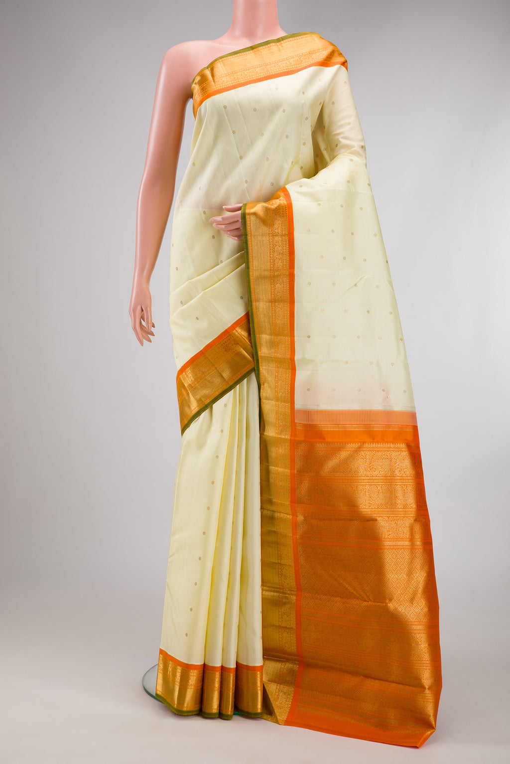 Pure Silk Pure Zari Cream Kanjivaram Saree with Zari Butta on the body and Zari Border.  displayed on a mannequin