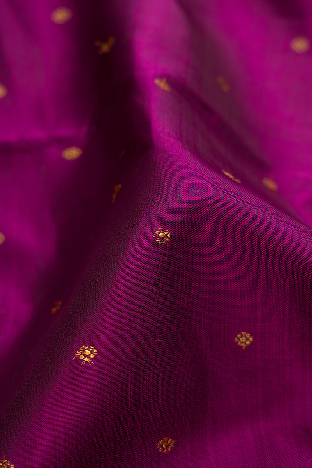Close up of Pure Silk Pure Zari Purple Kanjivaram Saree with Zari Butta on the body and Zari Border.  displaying folds