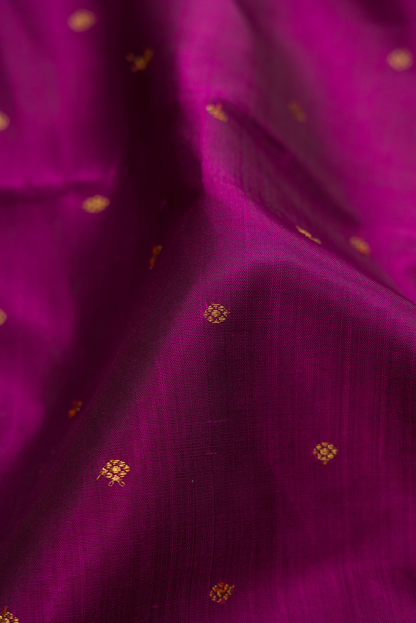 Close up of Pure Silk Pure Zari Purple Kanjivaram Saree with Zari Butta on the body and Zari Border.  displaying folds