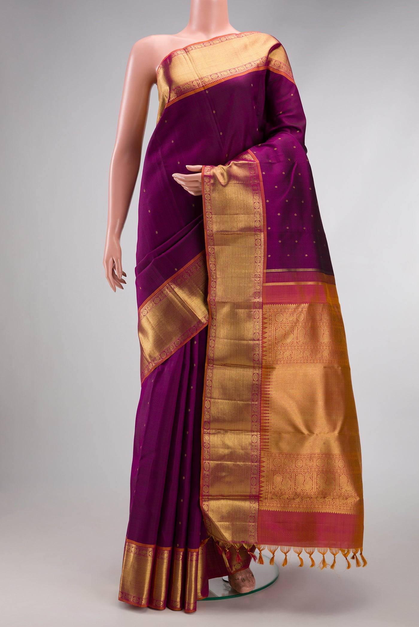 Pure Silk Pure Zari Purple Kanjivaram Saree with Zari Butta on the body and Zari Border.  displayed on a mannequin