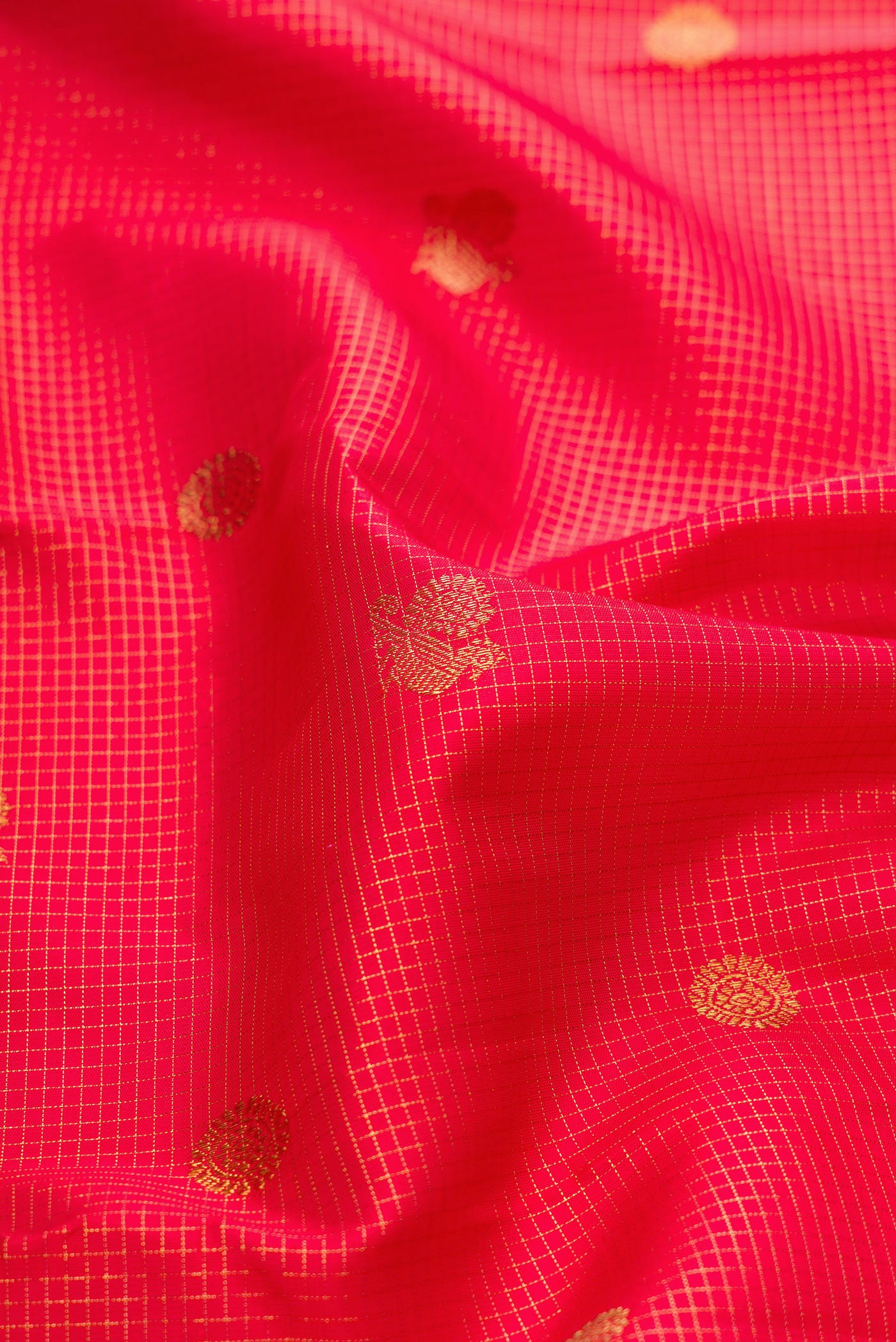 Close up of Pure Silk Pure Zari Dark Pink Dual Tone Kanjivaram Saree with Checked design on the body and Zari Border.  displaying folds