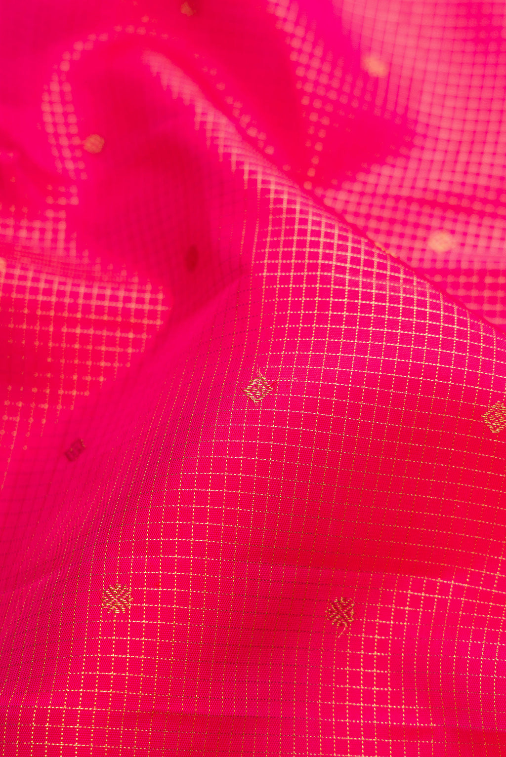 Close up of Pure Silk Pure Zari Pink Kanjivaram Saree with Checked design on the body and Zari Border.  displaying folds