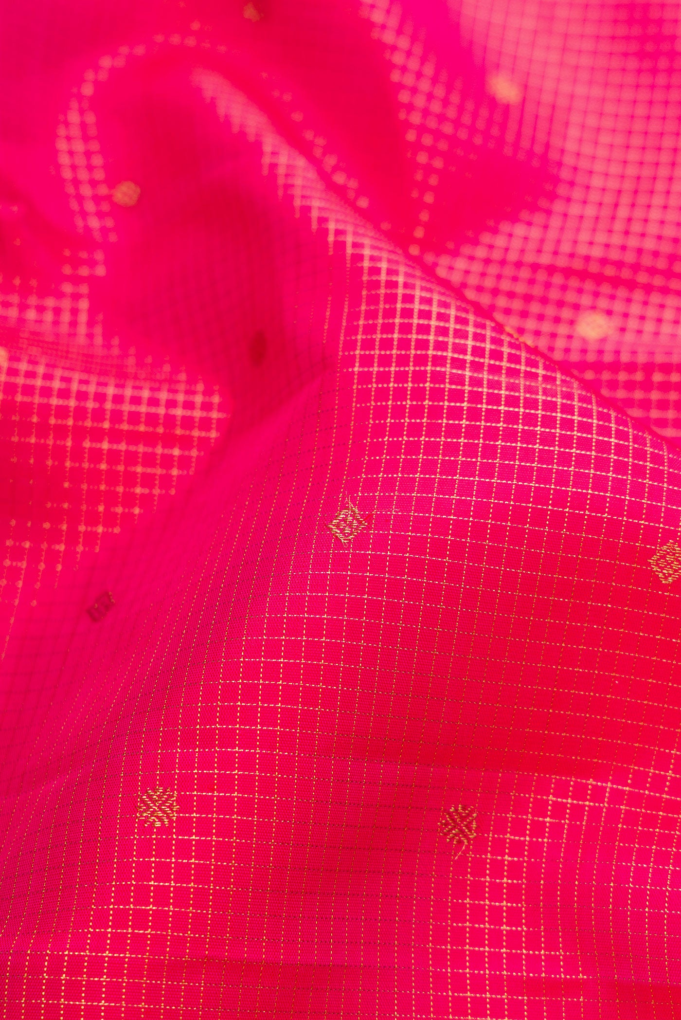 Close up of Pure Silk Pure Zari Pink Kanjivaram Saree with Checked design on the body and Zari Border.  displaying folds