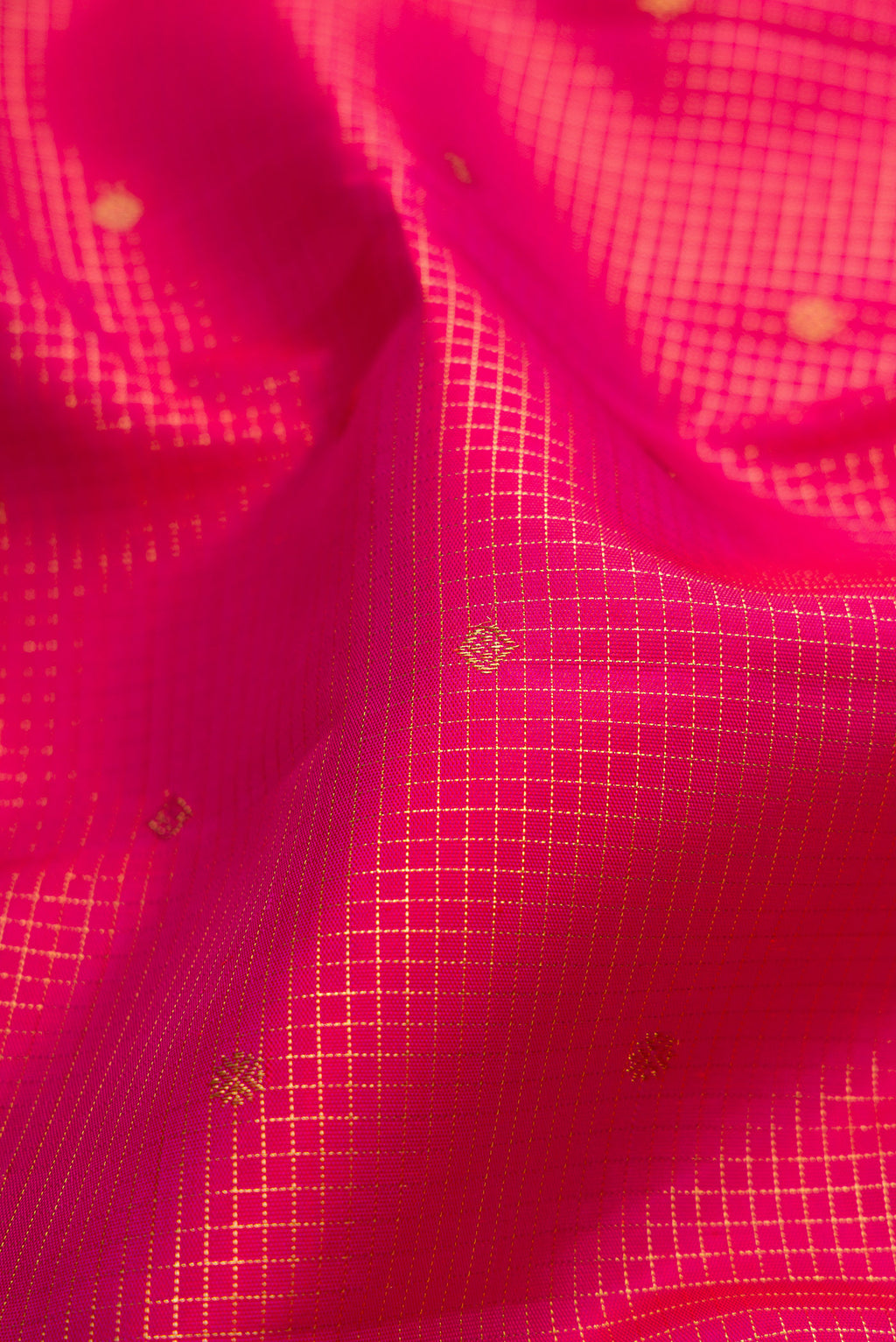 Close up of Pure Silk Pure Zari Dark Pink Kanjivaram Saree with Checked design on the body and Zari Border.  displaying folds