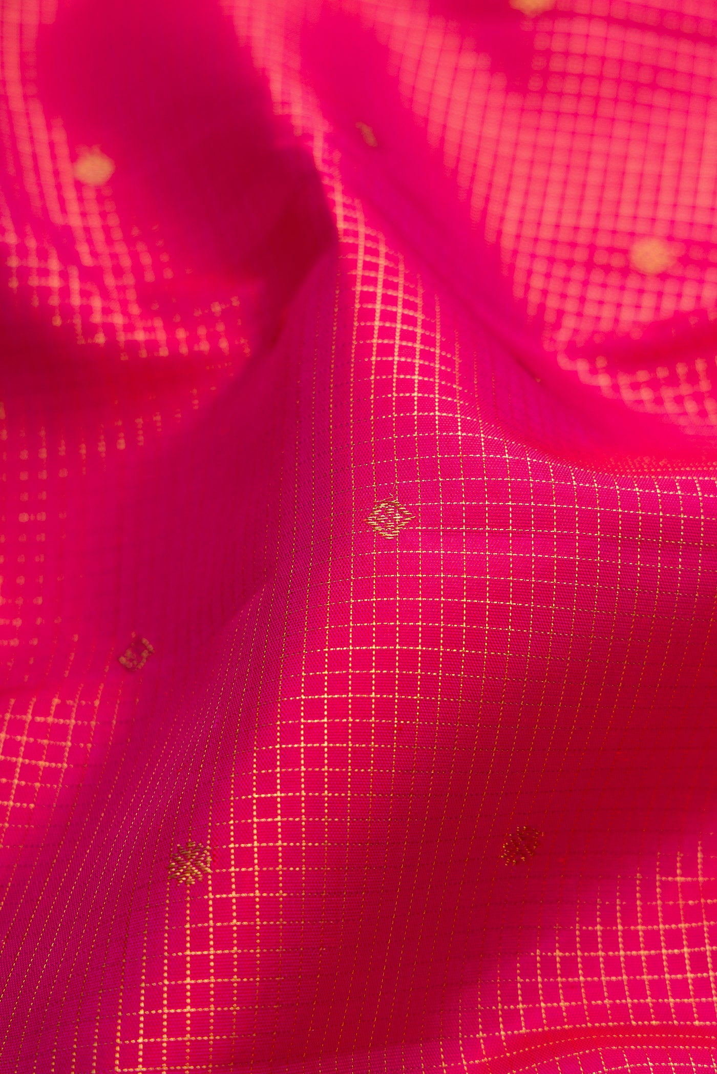 Close up of Pure Silk Pure Zari Dark Pink Kanjivaram Saree with Checked design on the body and Zari Border.  displaying folds