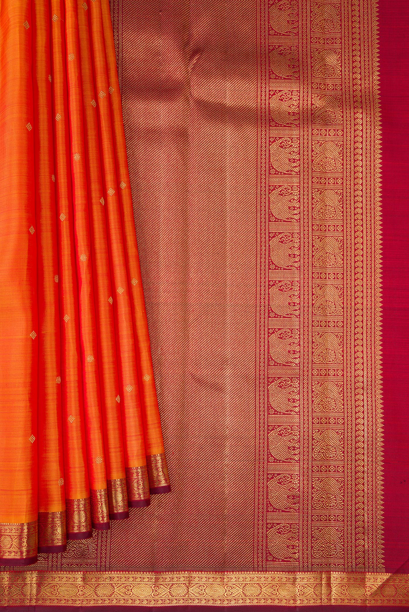 Pleats and pallu of Orange Dual Tone Kanchipuram Silk Saree with Zari Butta on the body and Zari Border. 
