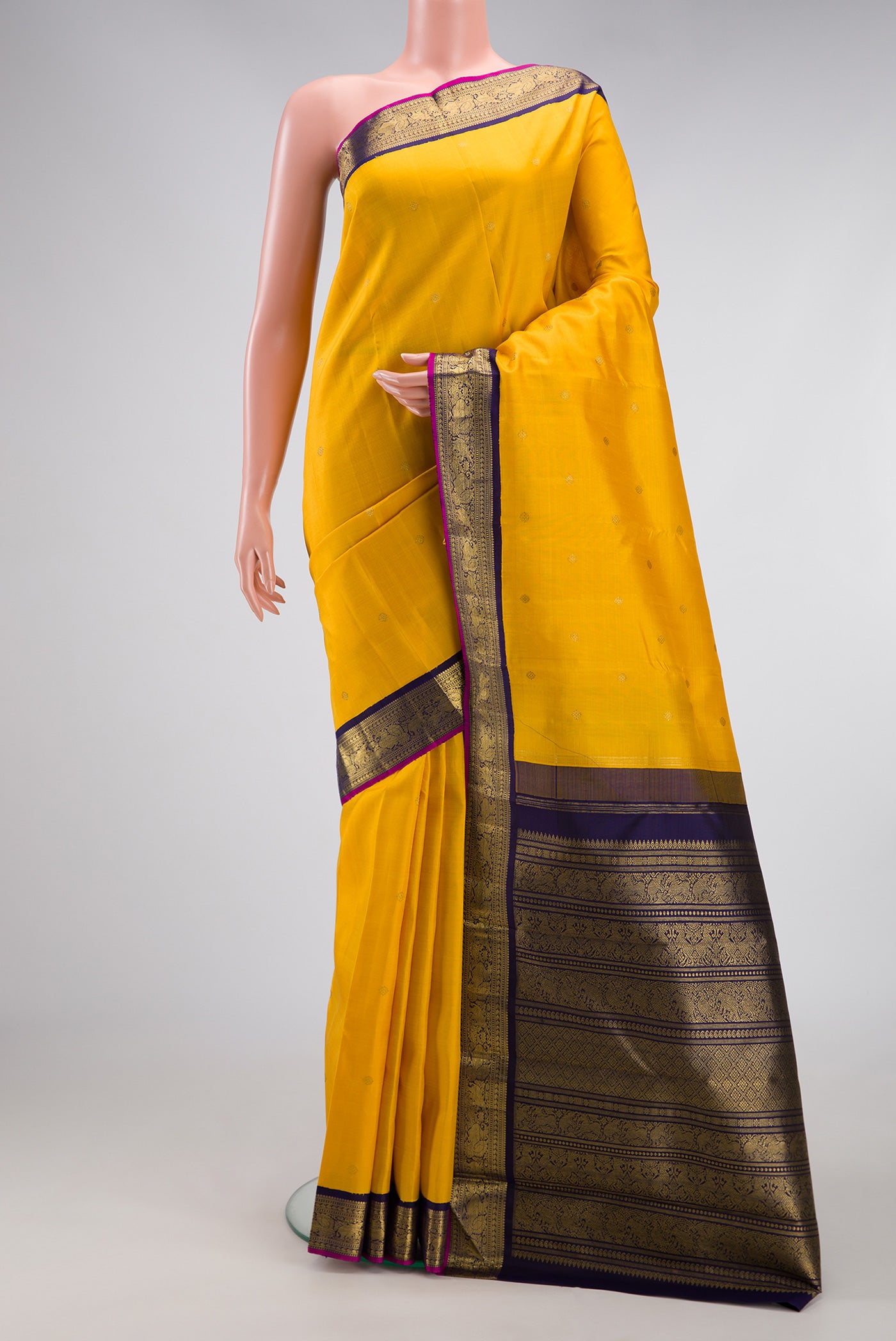 Pure Silk Pure Zari Yellow Dual Tone Kanjivaram Saree with Zari Butta on the body and Zari Border.  displayed on a mannequin