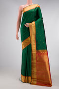 Pure Silk Pure Zari Green Dual Tone Kanjivaram Saree with Zari Butta on the body and Zari Border.  displayed on a mannequin