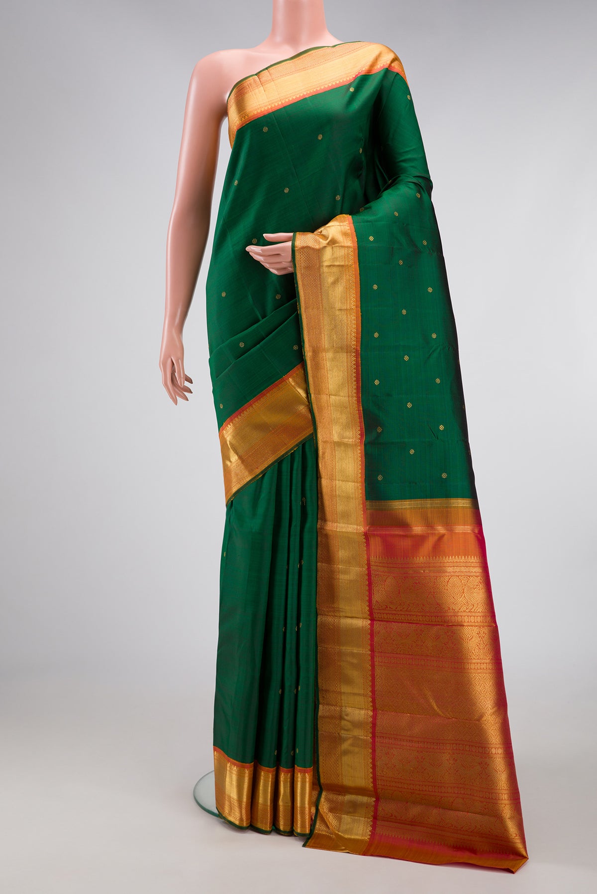 Pure Silk Pure Zari Green Dual Tone Kanjivaram Saree with Zari Butta on the body and Zari Border.  displayed on a mannequin