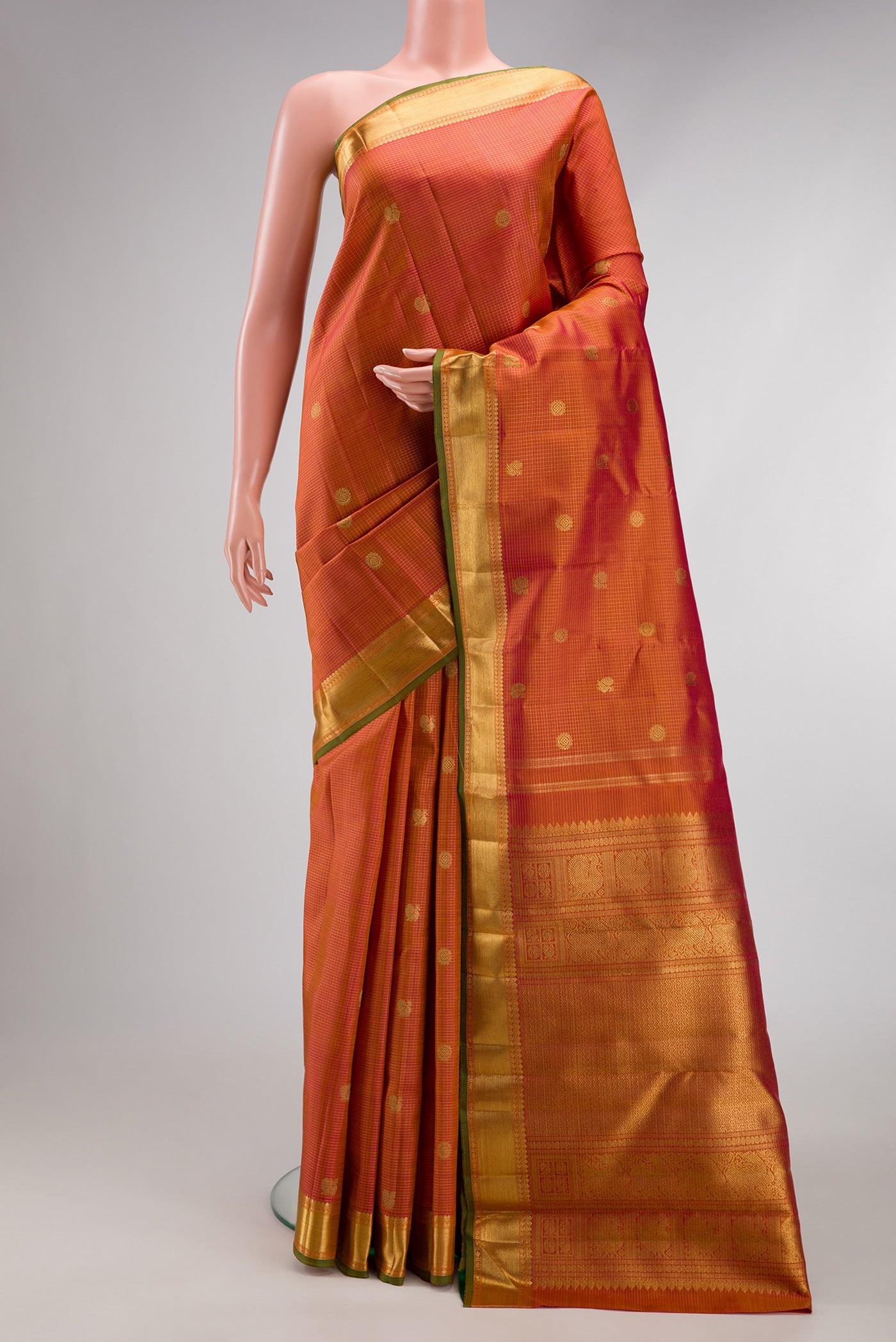Pure Silk Pure Zari Pinkish Yellow Dual Tone Kanjivaram Saree with Checked design on the body and Zari Border.  displayed on a mannequin