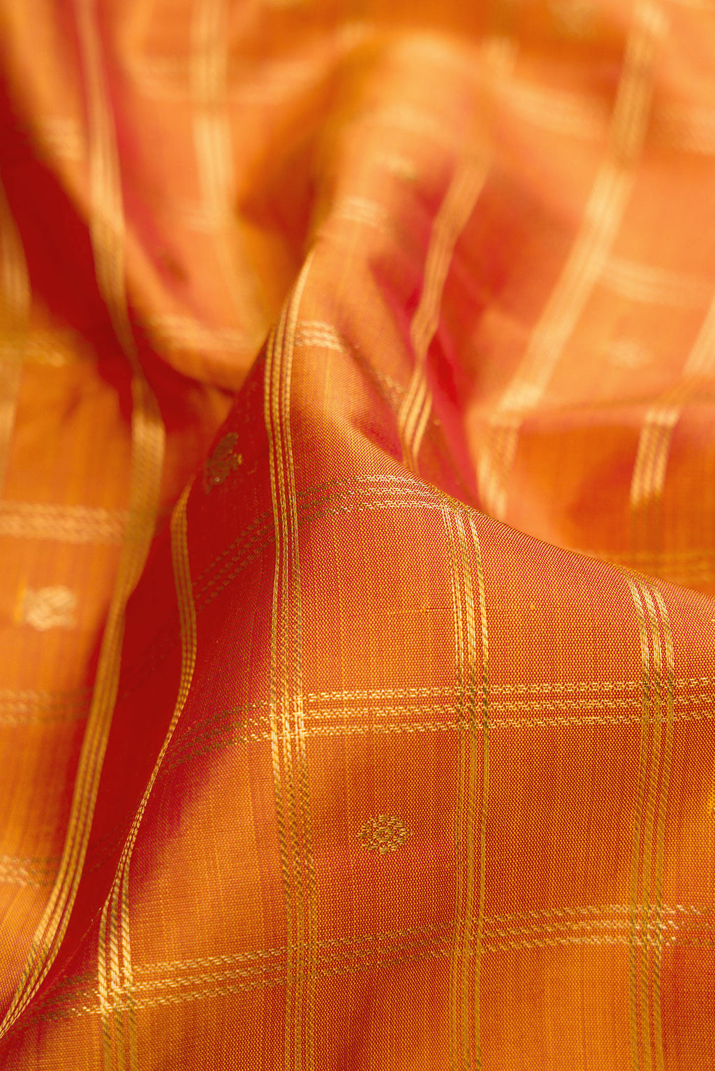 Close up of Pure Silk Pure Zari Mustard Dual Tone Kanjivaram Saree with Checked design on the body and Zari Border.  displaying folds