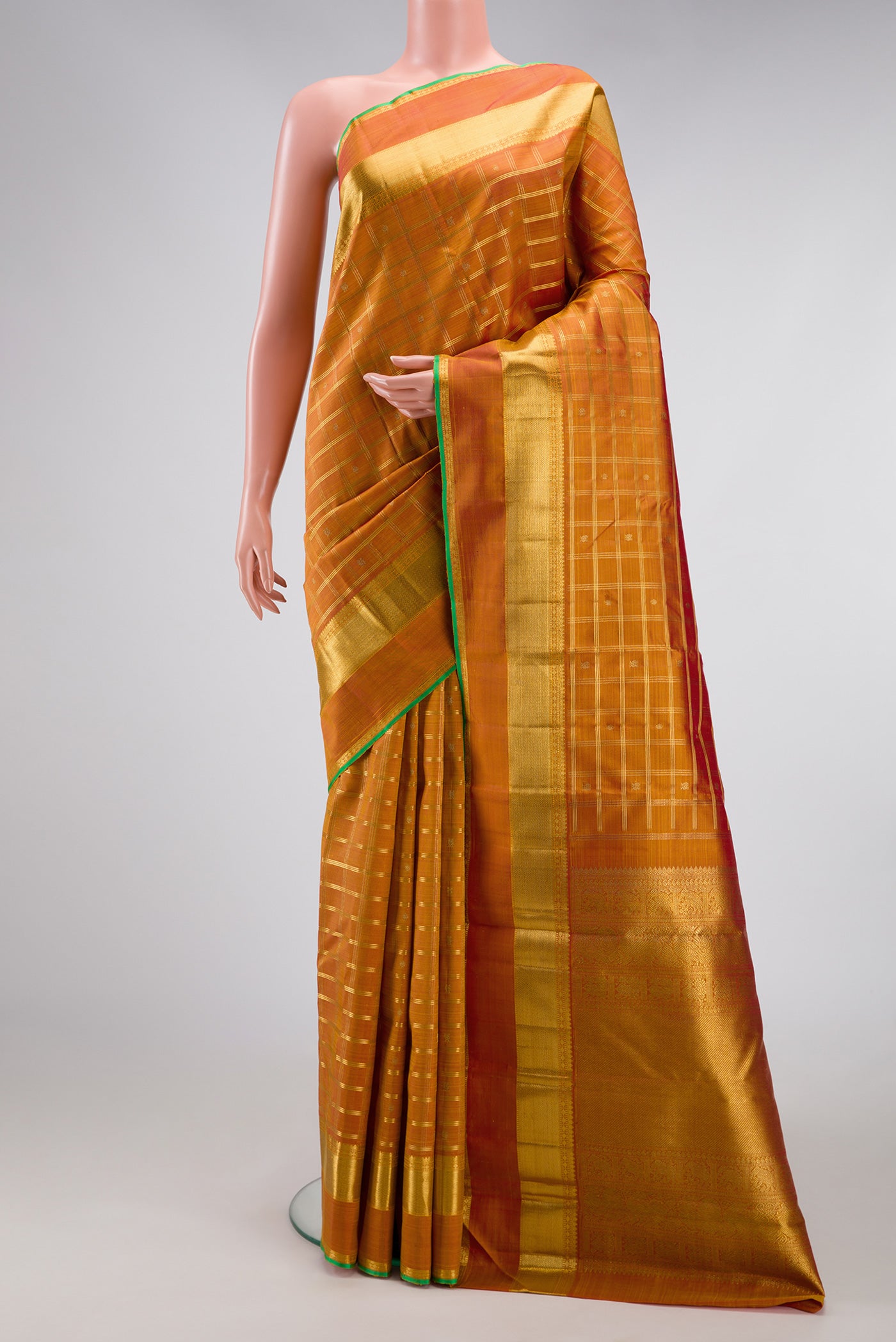Pure Silk Pure Zari Mustard Dual Tone Kanjivaram Saree with Checked design on the body and Zari Border.  displayed on a mannequin