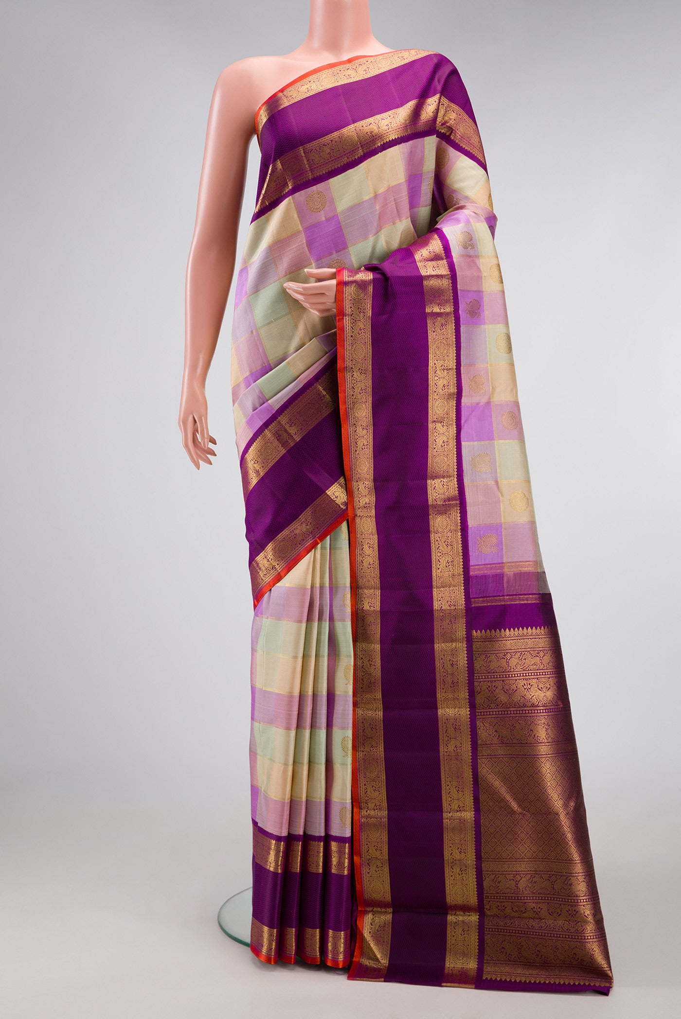 Pure Silk Pure Zari Multi Color Kanjivaram Saree with Checked design on the body and Zari Border.  displayed on a mannequin