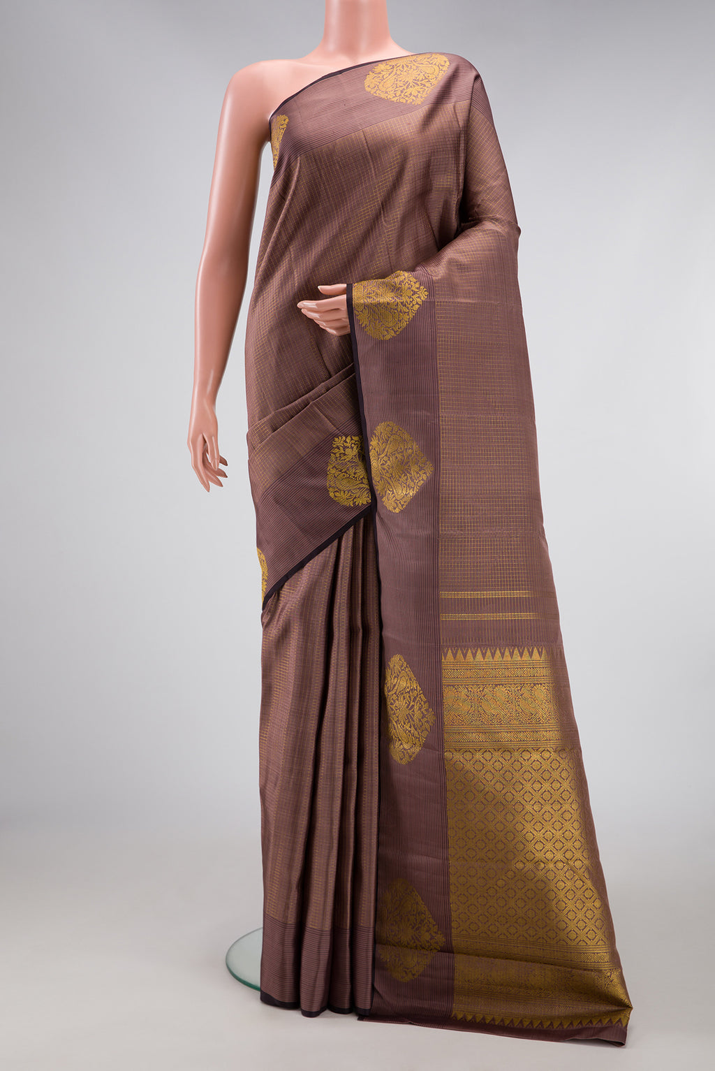 Brown Dual Tone Kanjivaram Silk Saree with Checked design on the body and Zari Border.  displayed on a mannequin