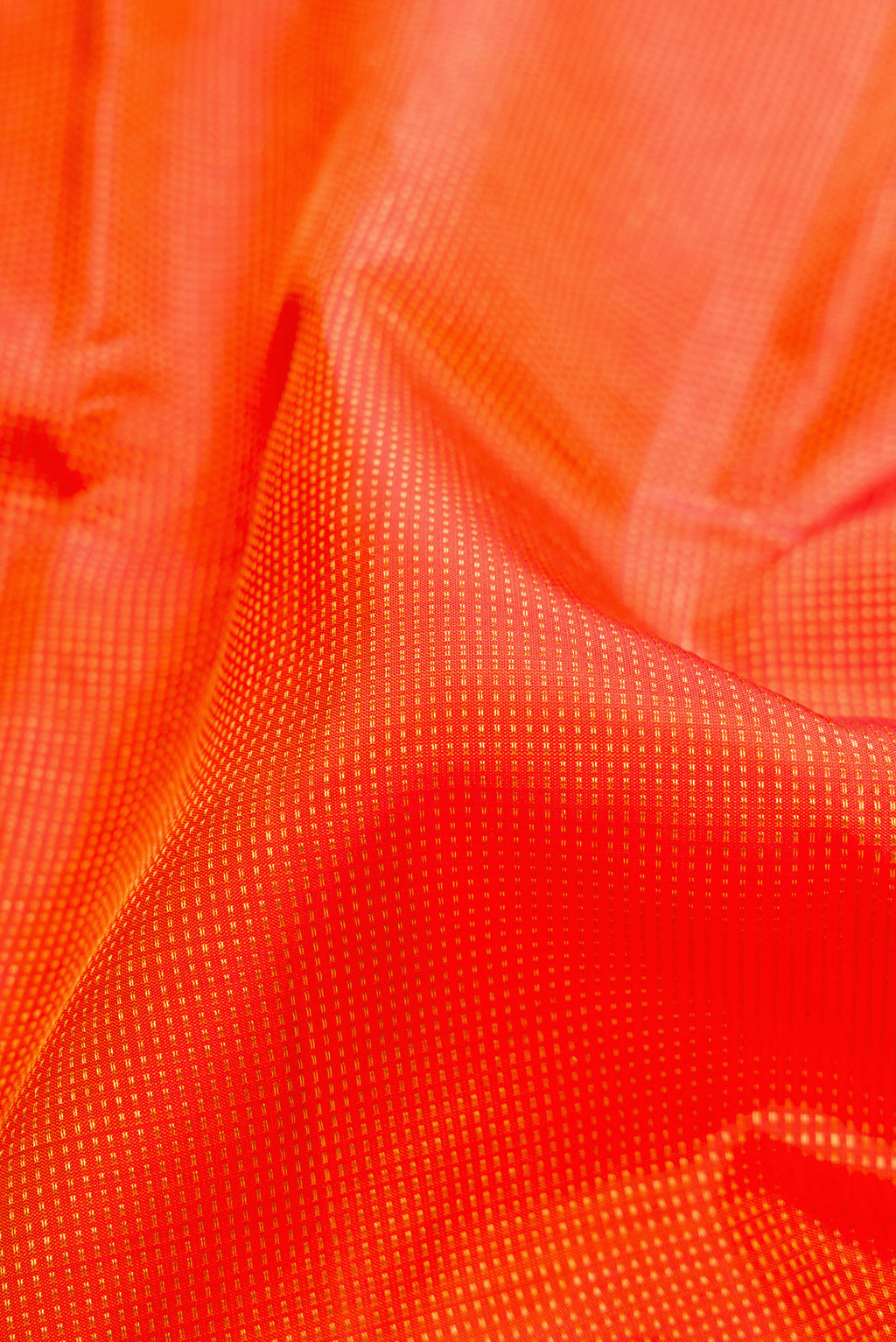 Close up of Orange Kanjivaram Silk Saree with Stripes on the body and Fancy Border.  displaying folds