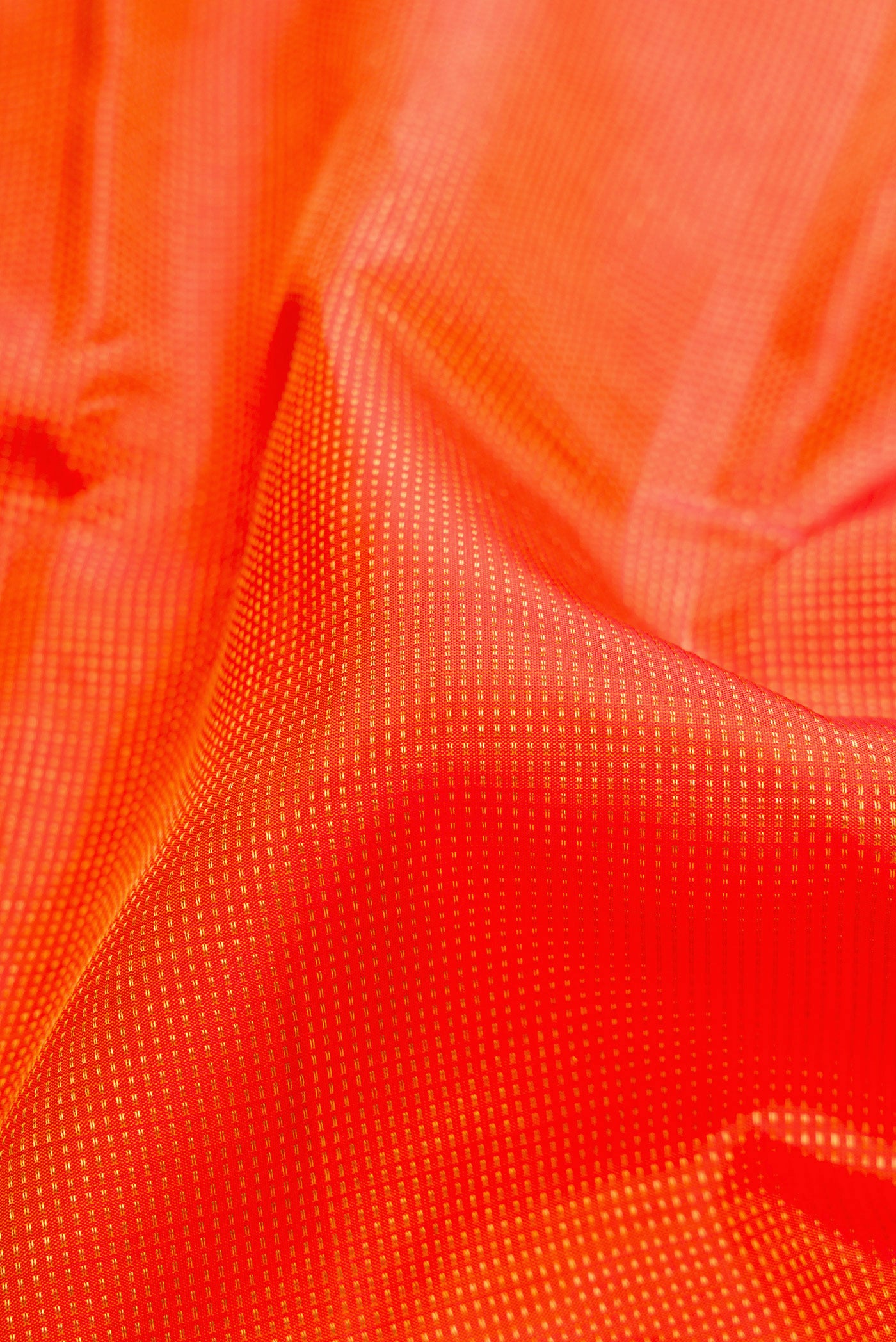 Close up of Orange Kanjivaram Silk Saree with Stripes on the body and Fancy Border.  displaying folds