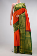 Orange Dual Tone Kanchipuram Silk Saree with Zari Butta on the body and Zari Border.  displayed on a mannequin