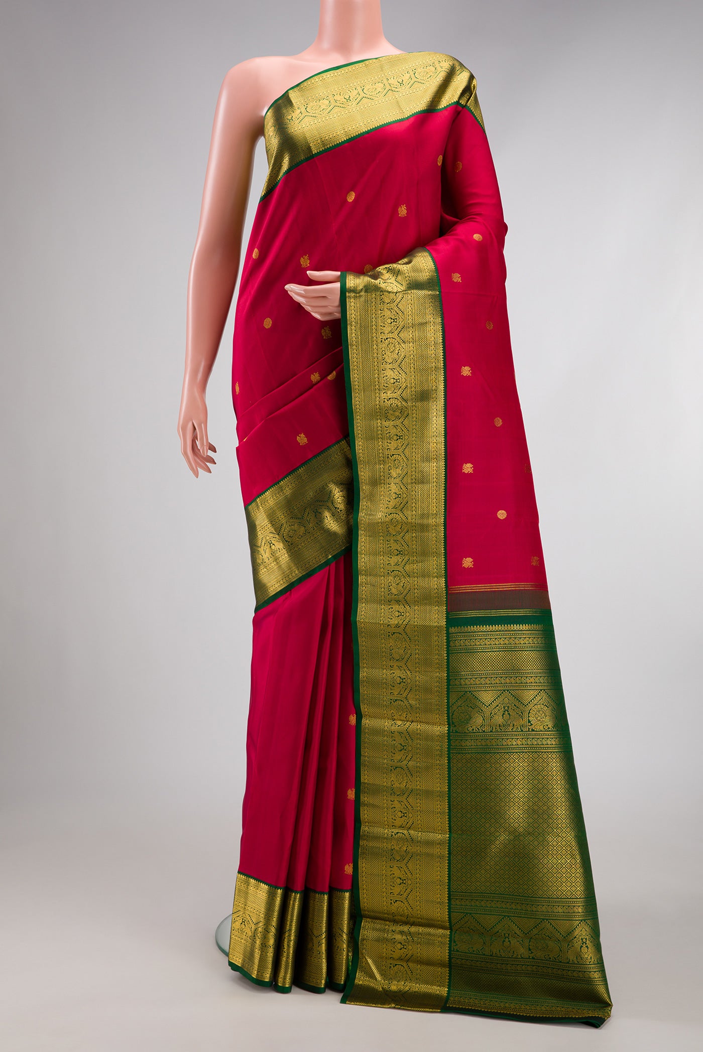 Red Kanchipuram Silk Saree with Zari Butta on the body and Zari Border.  displayed on a mannequin